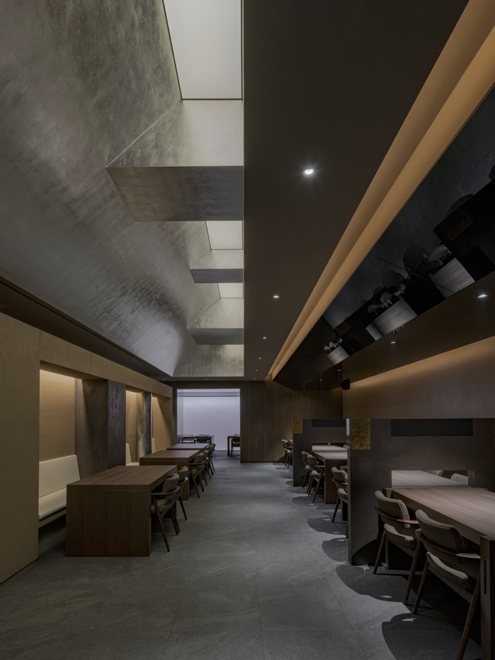 An inviting restaurant interior with wooden tables and chairs, providing ample seating options for guests in a warm and cozy atmosphere
