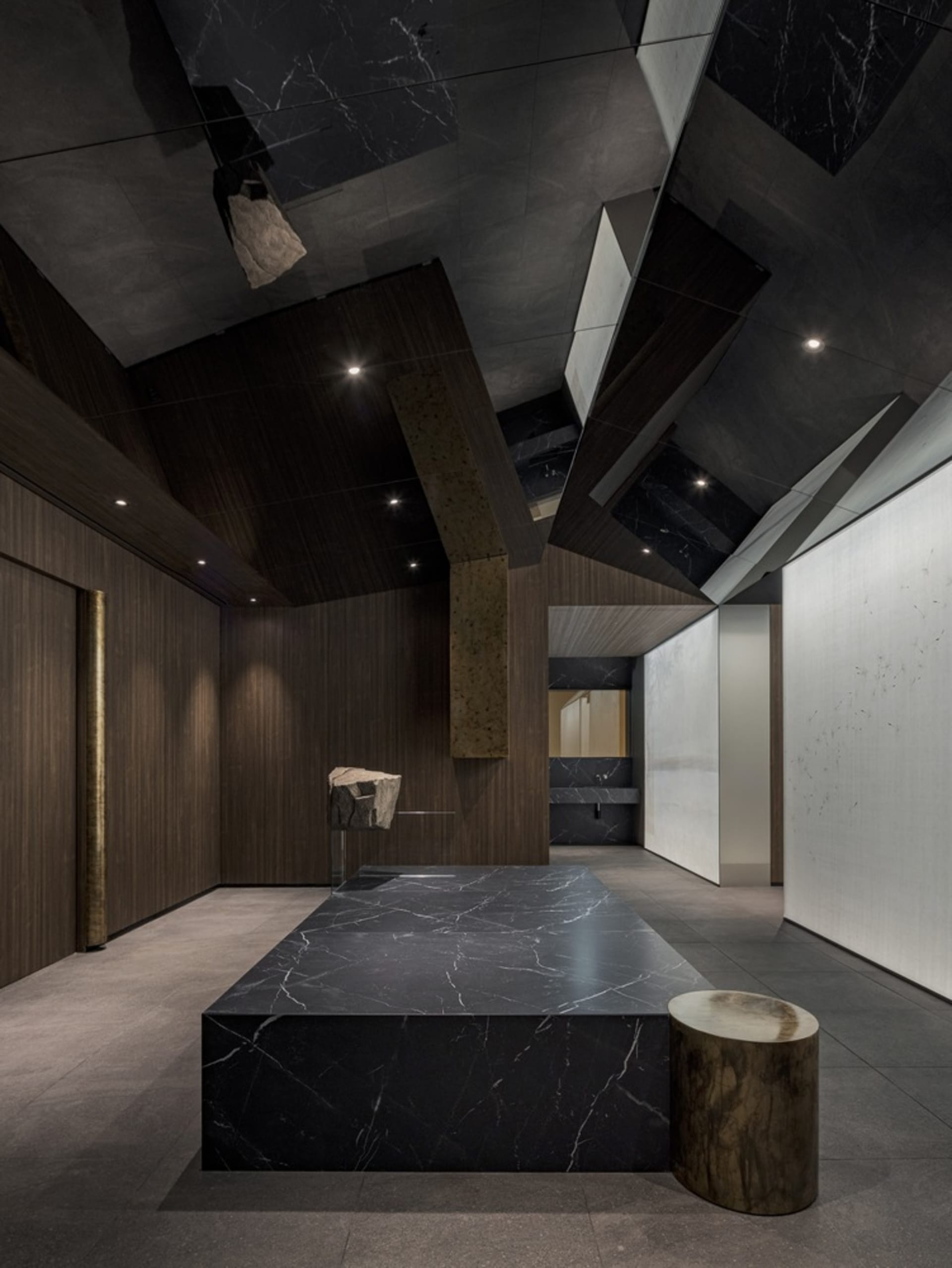 A modern kitchen with a black marble countertop, two sinks, and a contemporary design, giving an elegant and luxurious atmosphere