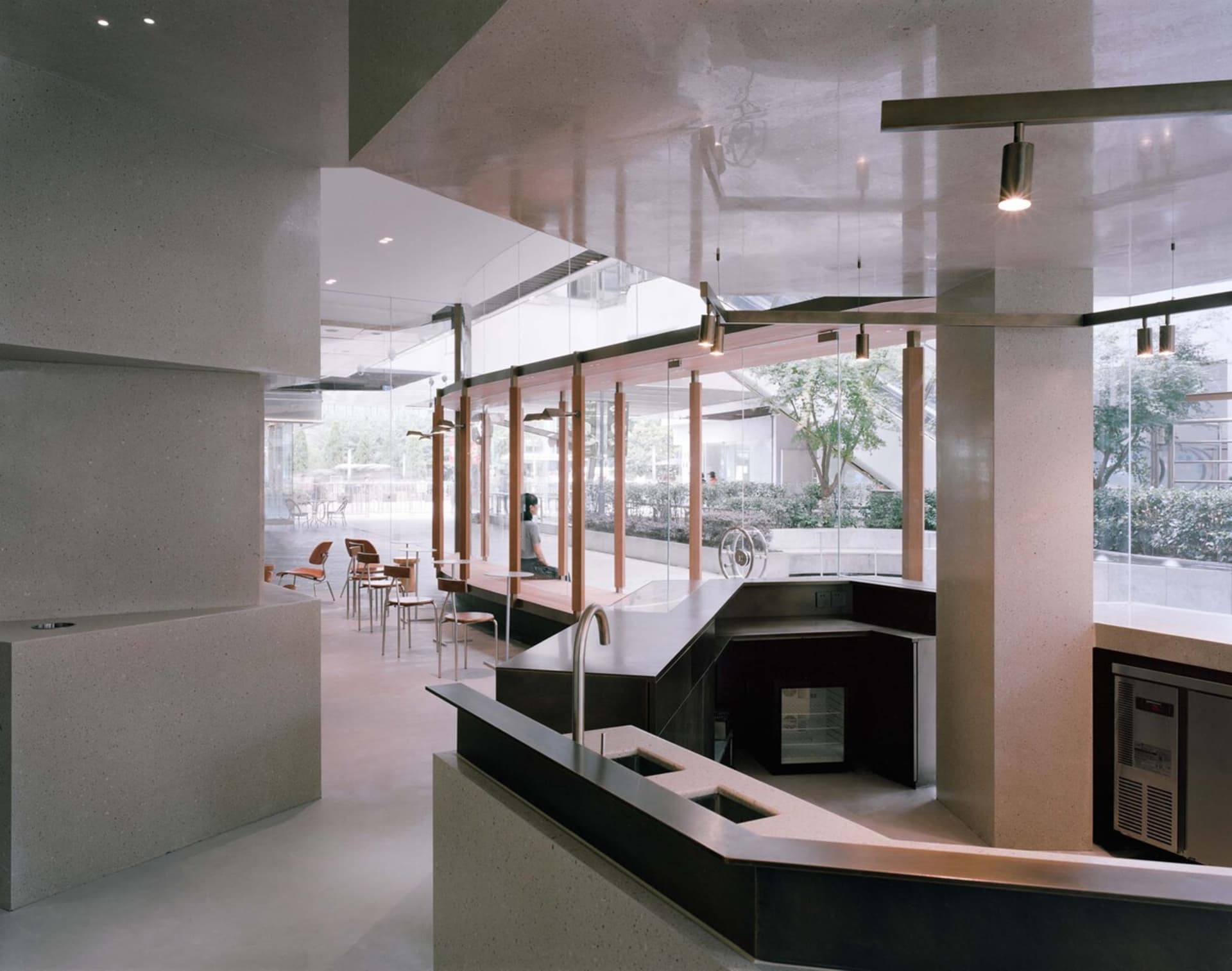 Modern restaurant interior with a large bar area, fireplace, and comfortable seating for guests