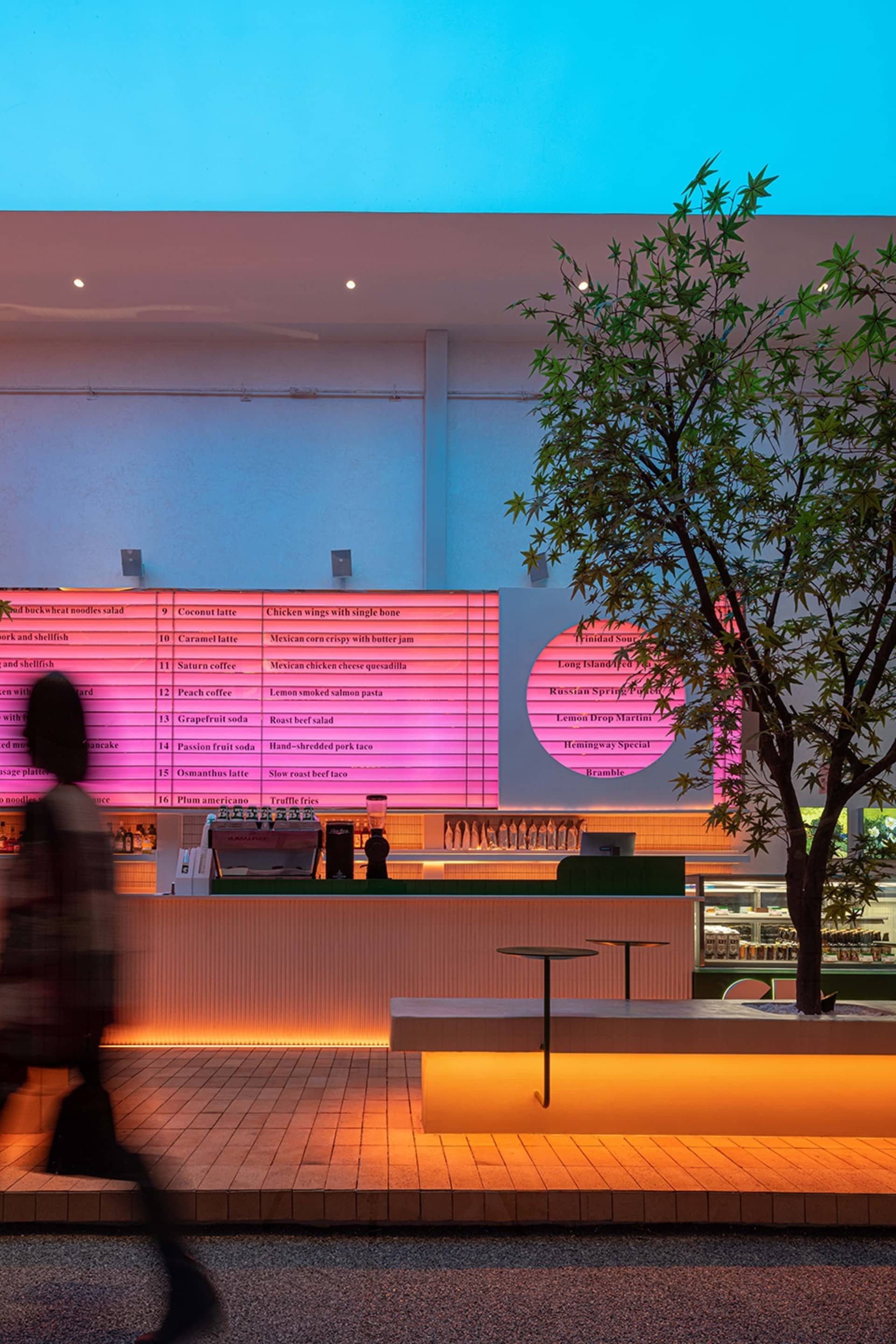 Inviting cafe space with a counter and seating area, featuring bottles and cups on display