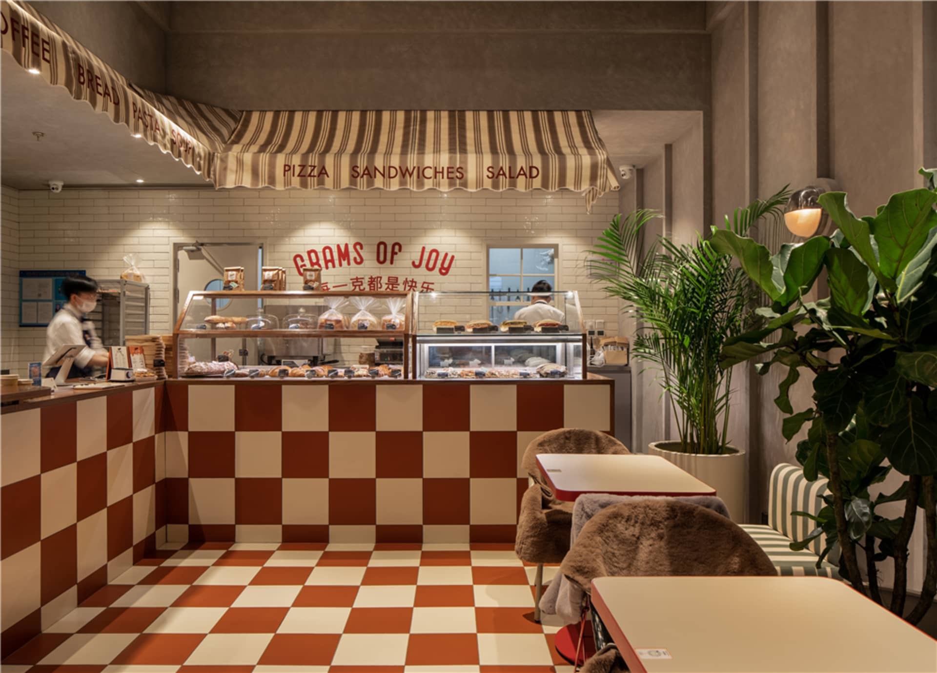 Inviting restaurant interior with a counter and chairs, displaying a variety of food items and providing a comfortable dining experience