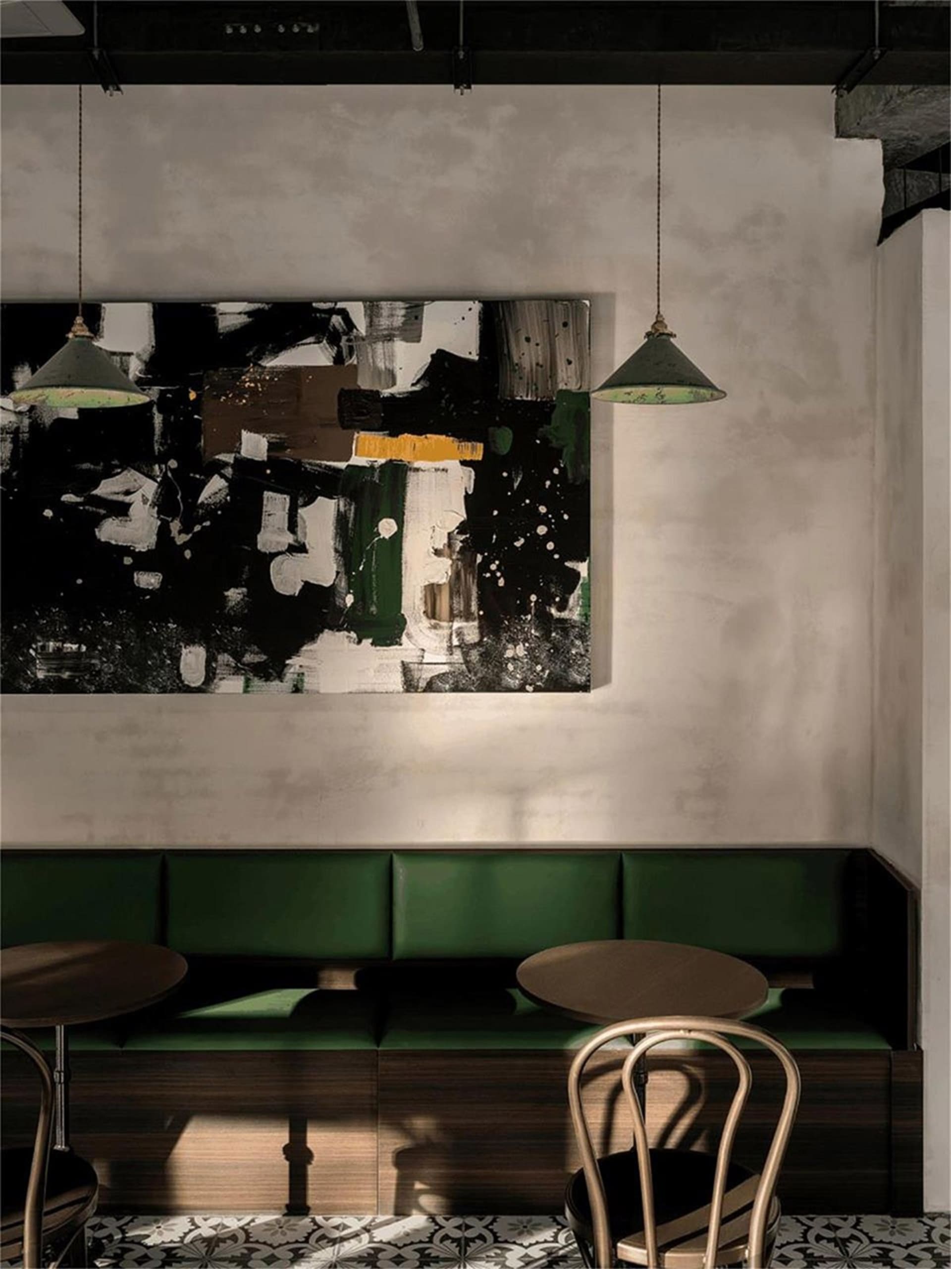 Inviting restaurant interior with green benches and tables, creating a comfortable dining experience