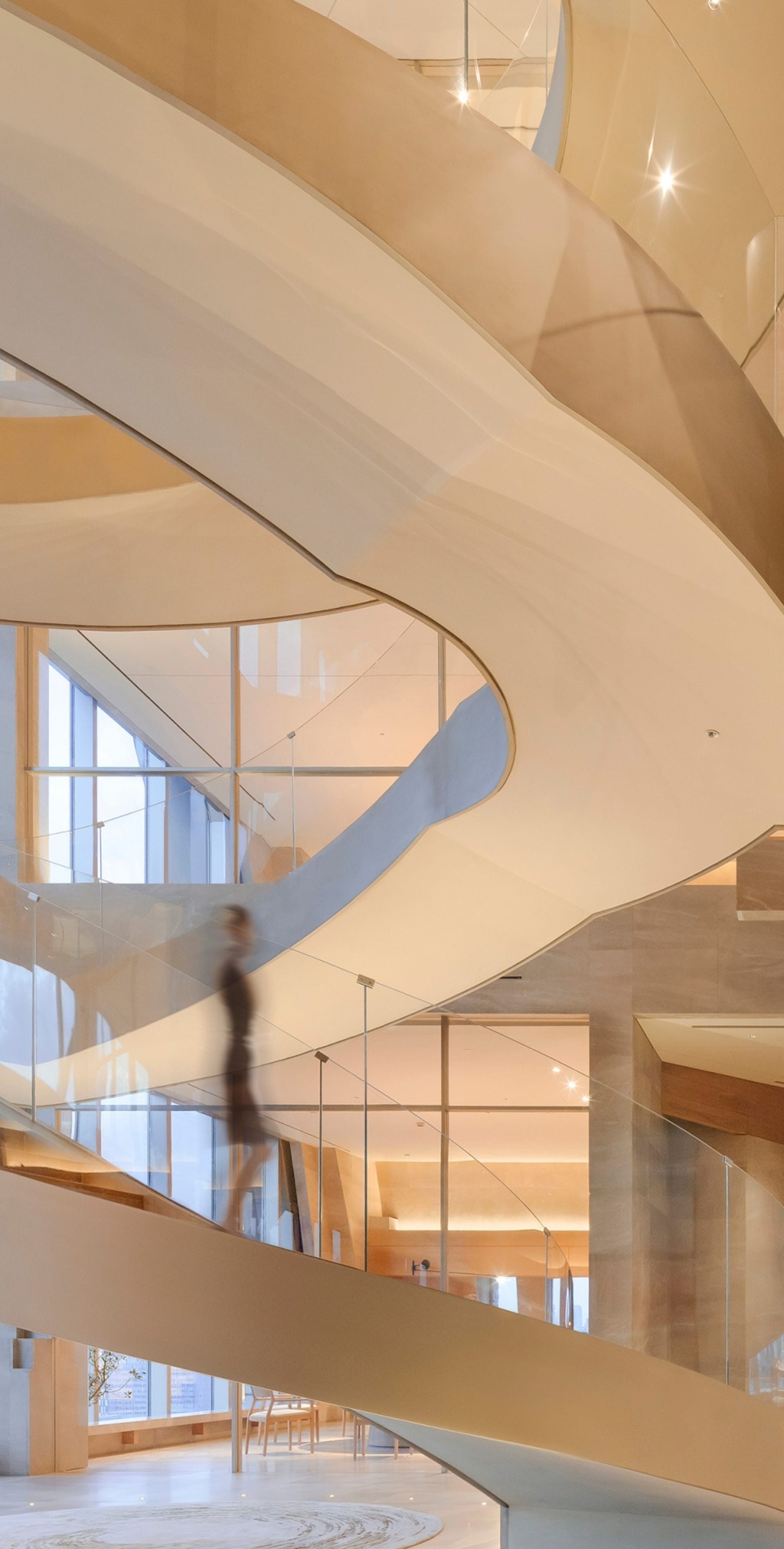 A grand staircase with wooden steps and a metal railing, set against a rendered background, suggesting a sense of grandeur and elegance
