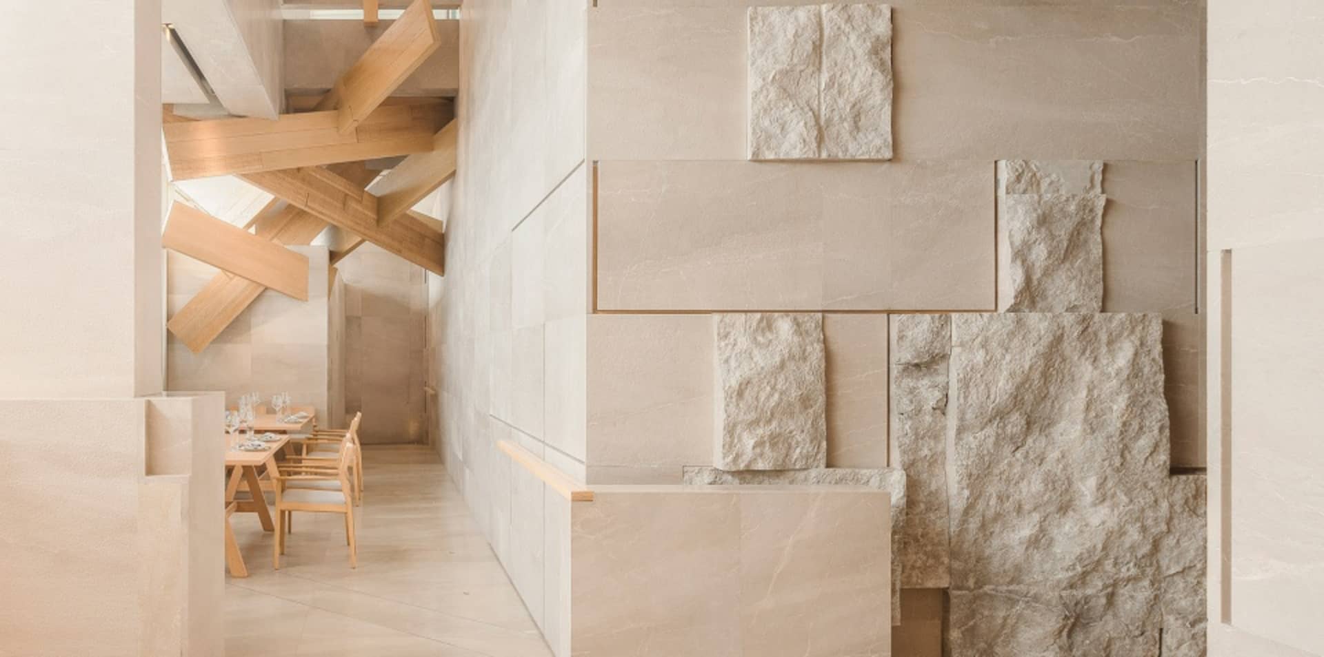 Contemporary interior space with a large marble wall, two chairs, and a sophisticated atmosphere
