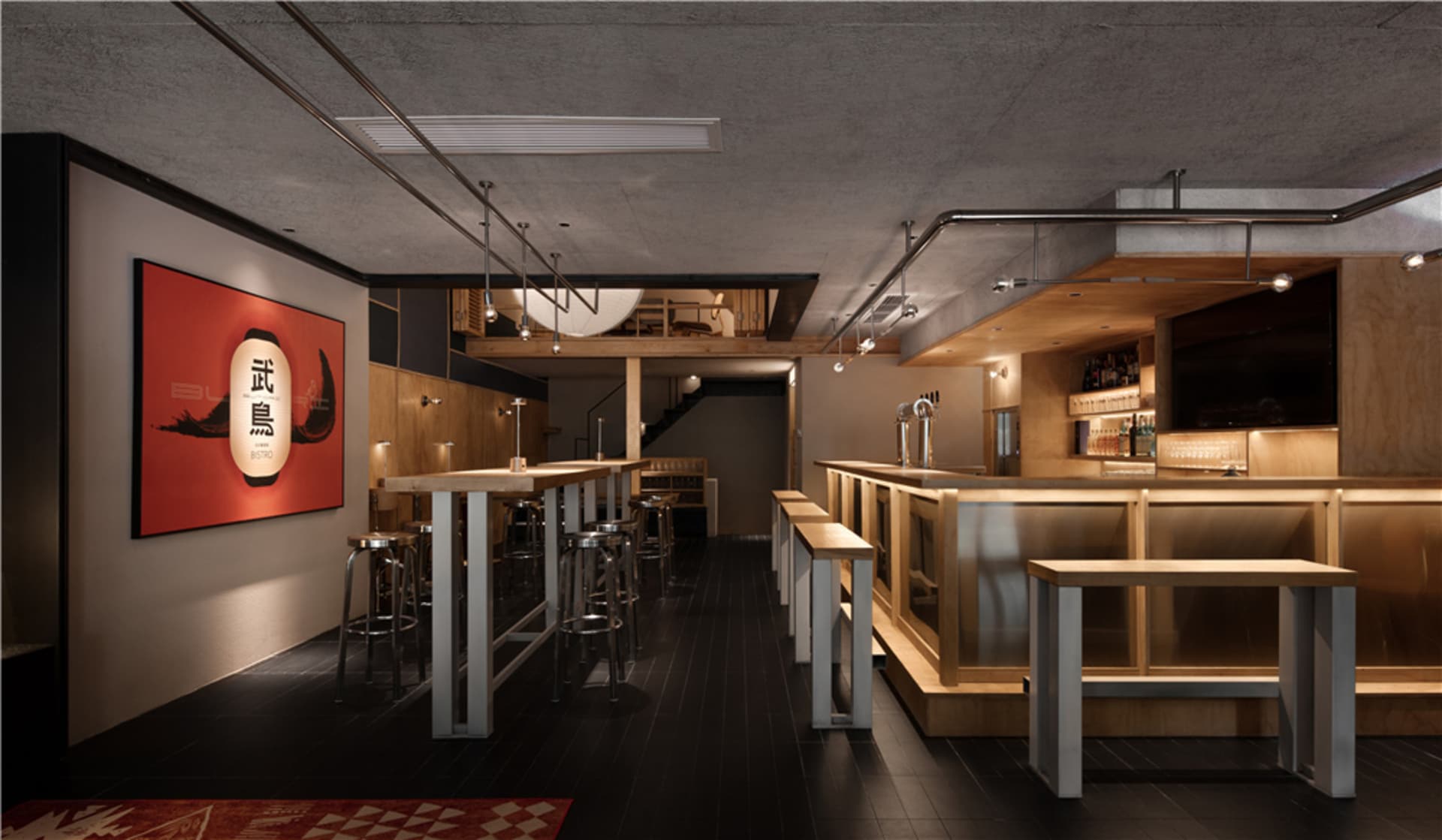A cozy bar area with a wooden countertop, stools, and chairs, creating a welcoming atmosphere for patrons