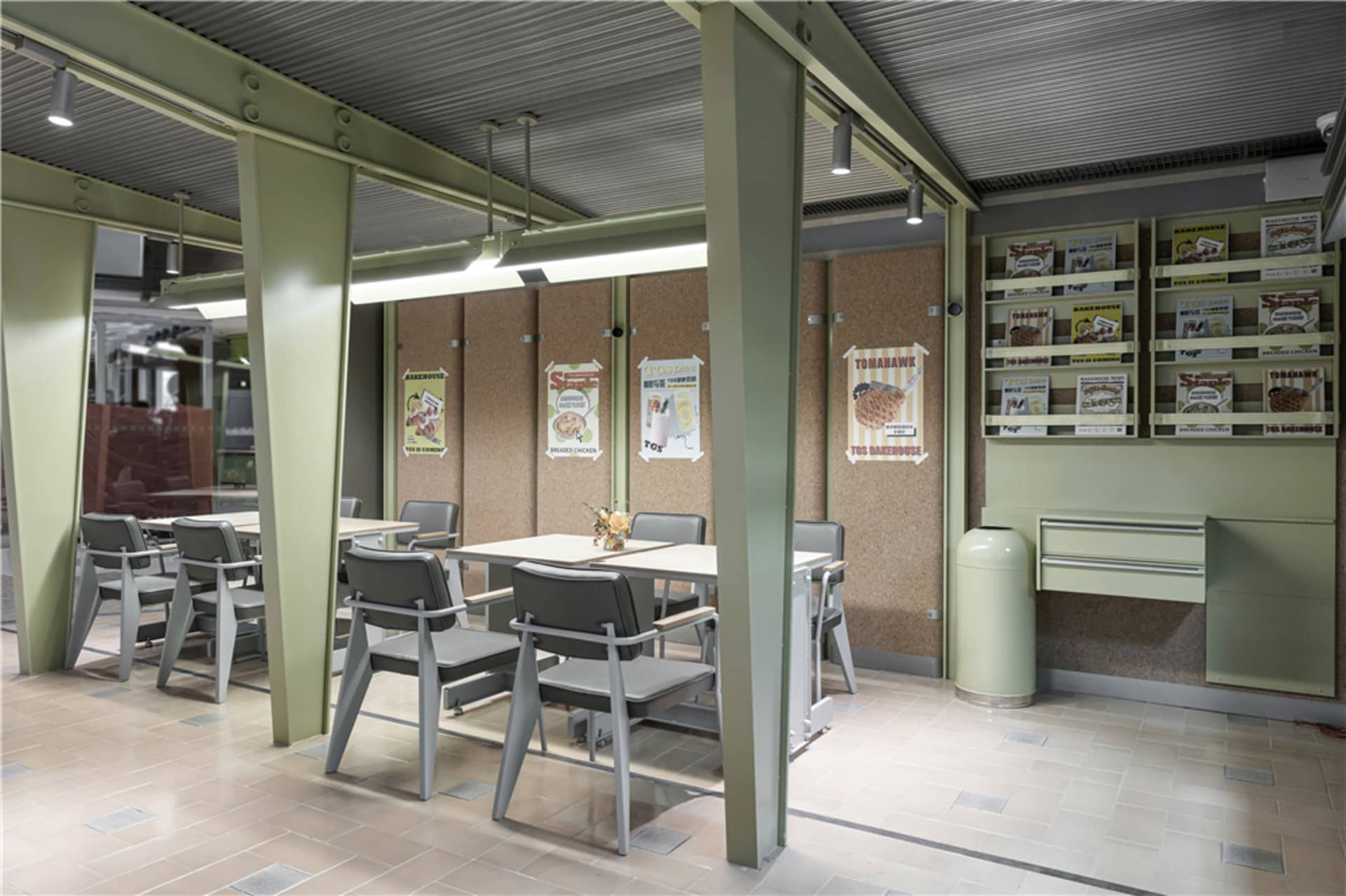A cozy restaurant dining area with a greenish hue, soft lighting, and comfortable seating around a central table