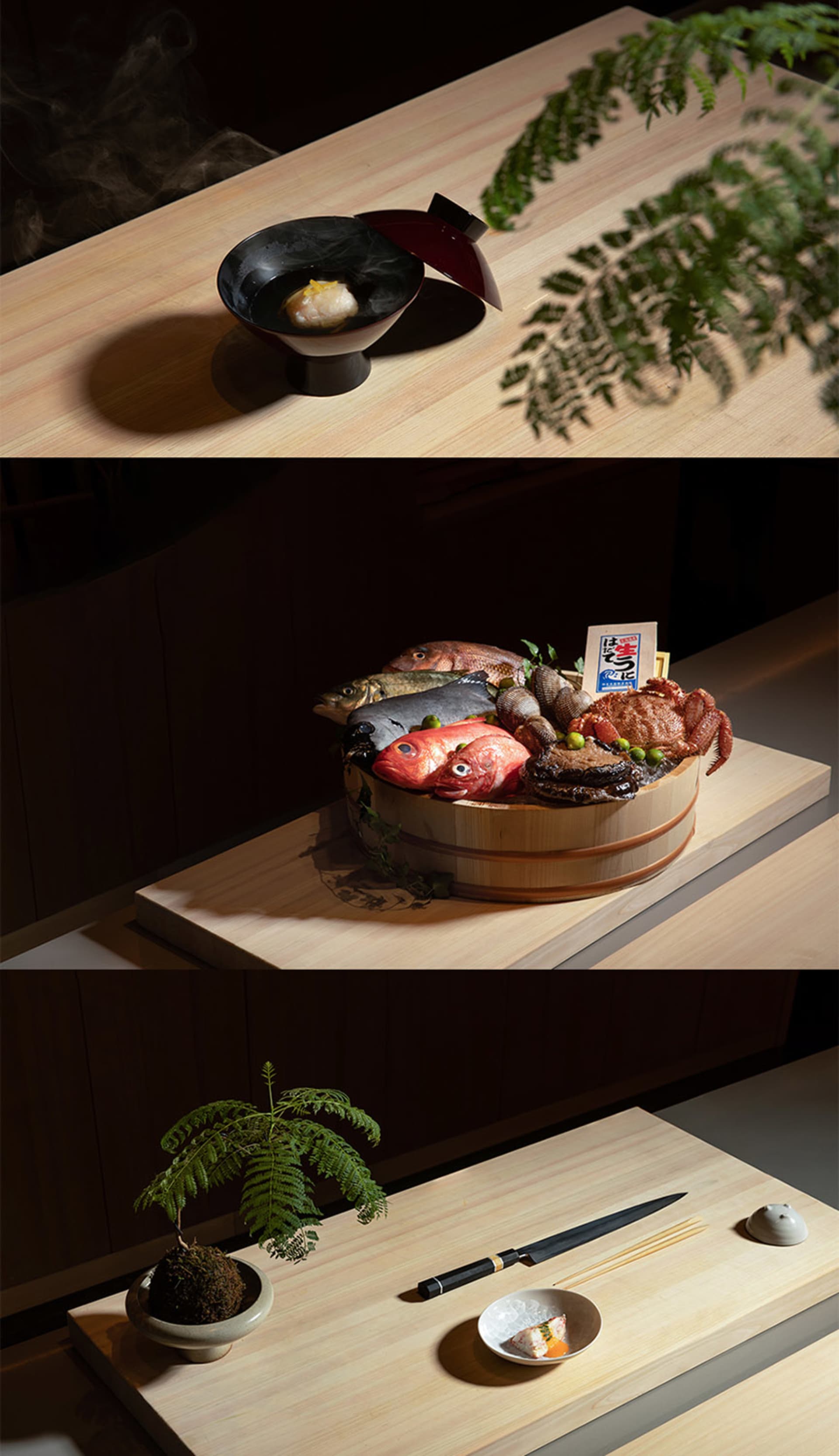 餐廳區域內的餐桌，擺放著一碗魚、一盤海鮮與盆栽