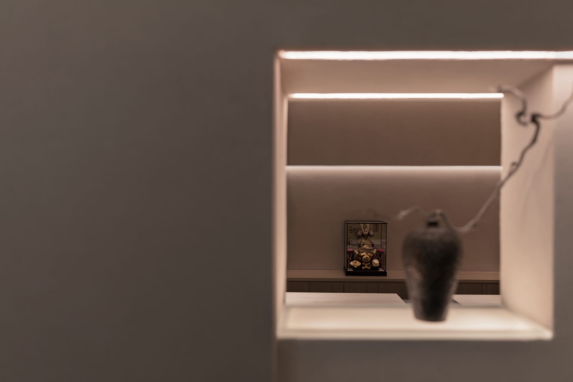 A calm and minimalistic interior space with ceramic vases on a table and against a white wall