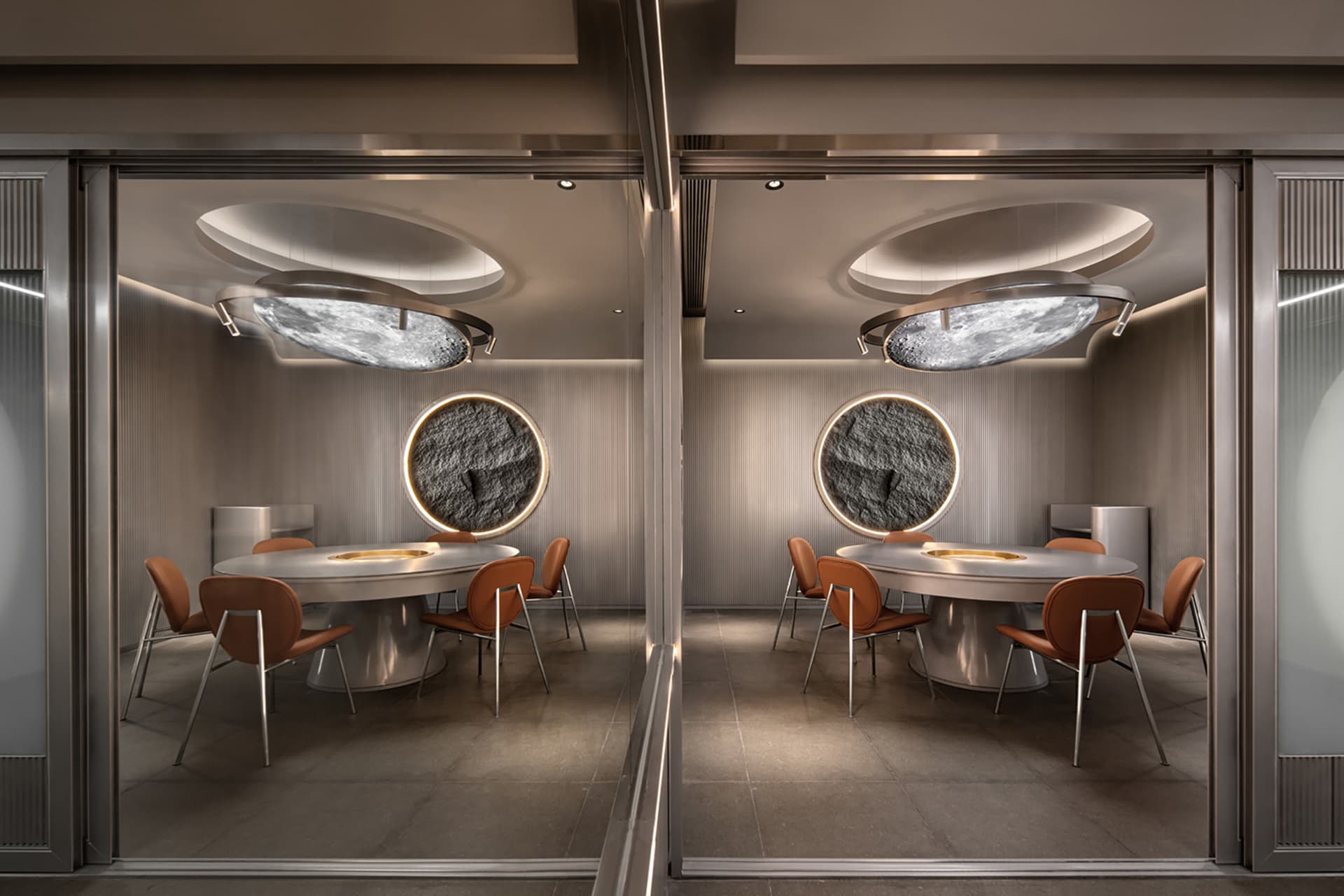 A well-lit restaurant dining area with multiple round tables and chairs, gray and white walls, and a comfortable atmosphere