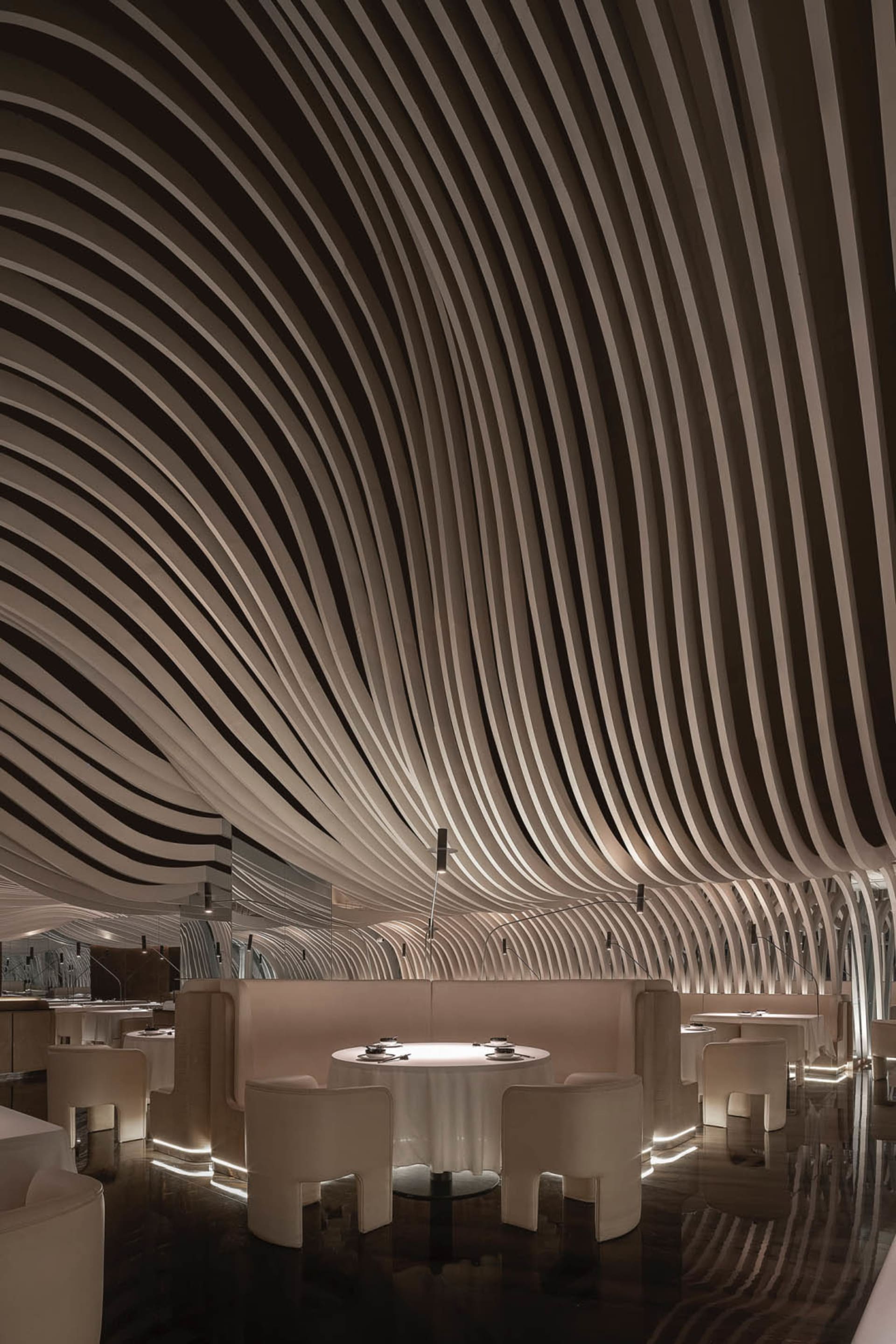 A modern restaurant interior with multiple dining tables and chairs, creating a comfortable and inviting atmosphere for guests
