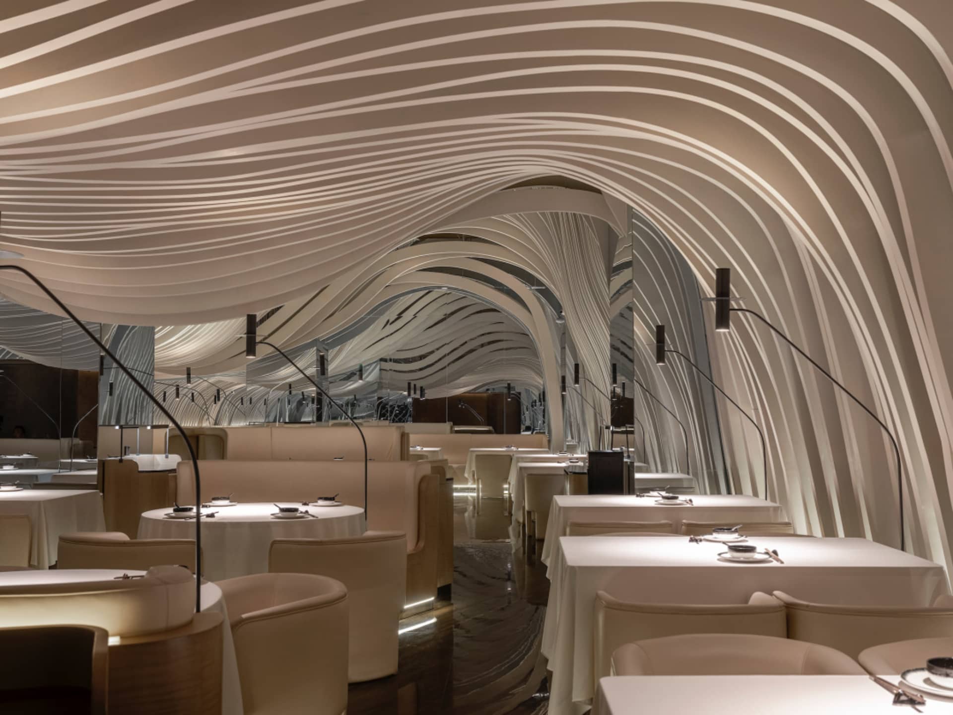 Sophisticated dining space with multiple tables and chairs, contemporary design elements, and a modern atmosphere