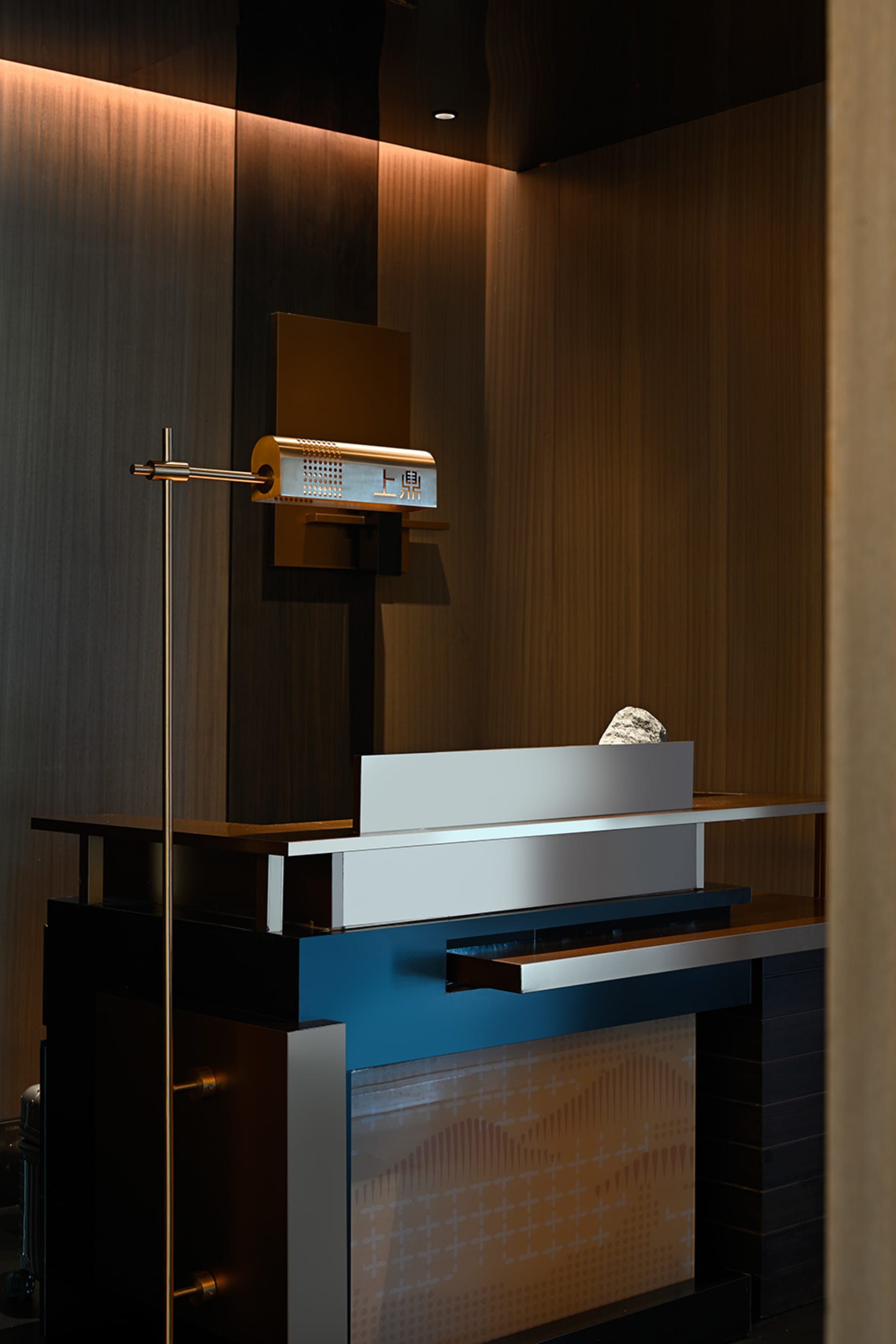Modern bathroom with two sinks, one metal and one possibly metal, and a wooden-framed mirror, with a sleek and modern aesthetic