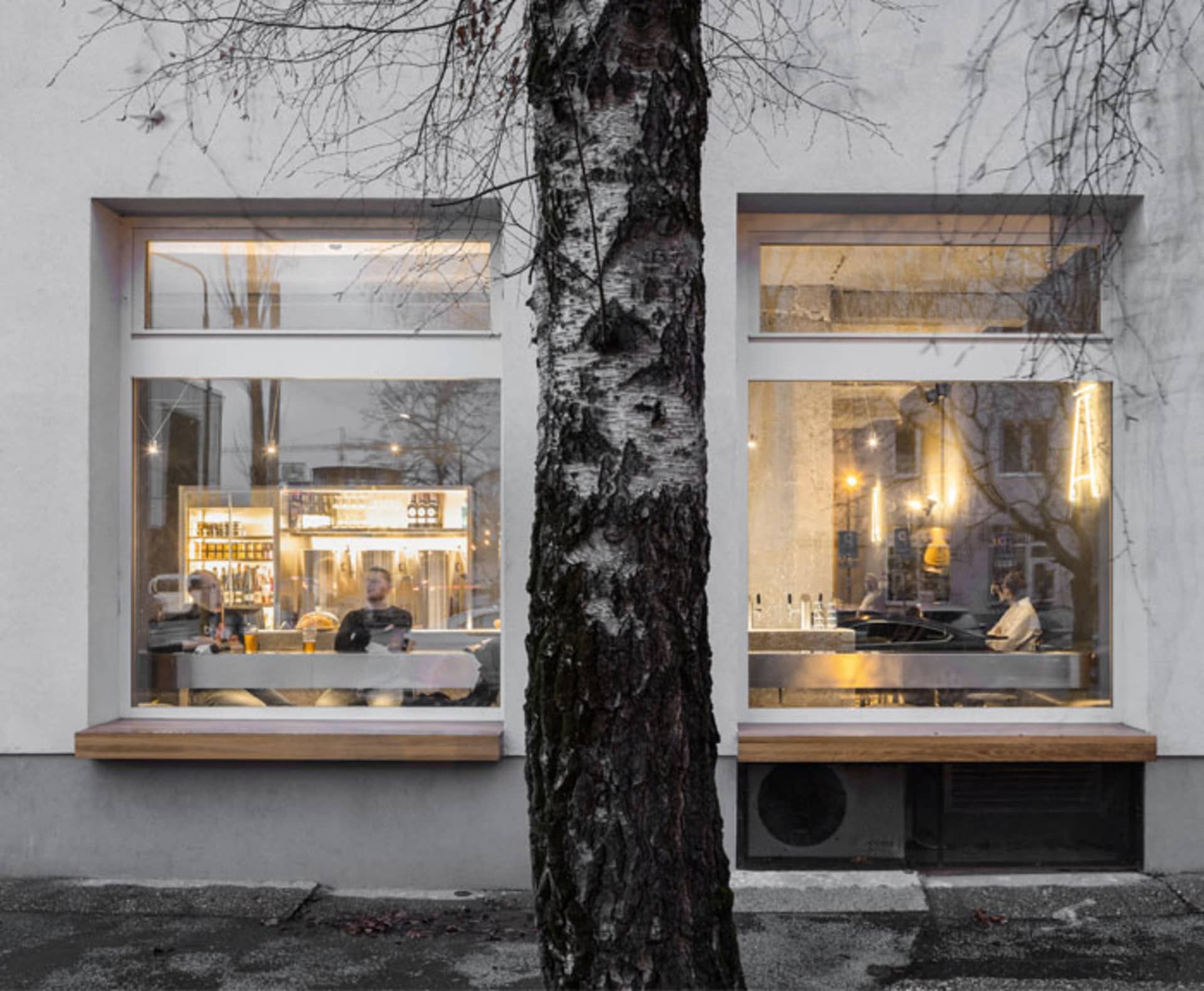 A well-lit restaurant with multiple tables and chairs, some with cups, set in a comfortable and inviting atmosphere