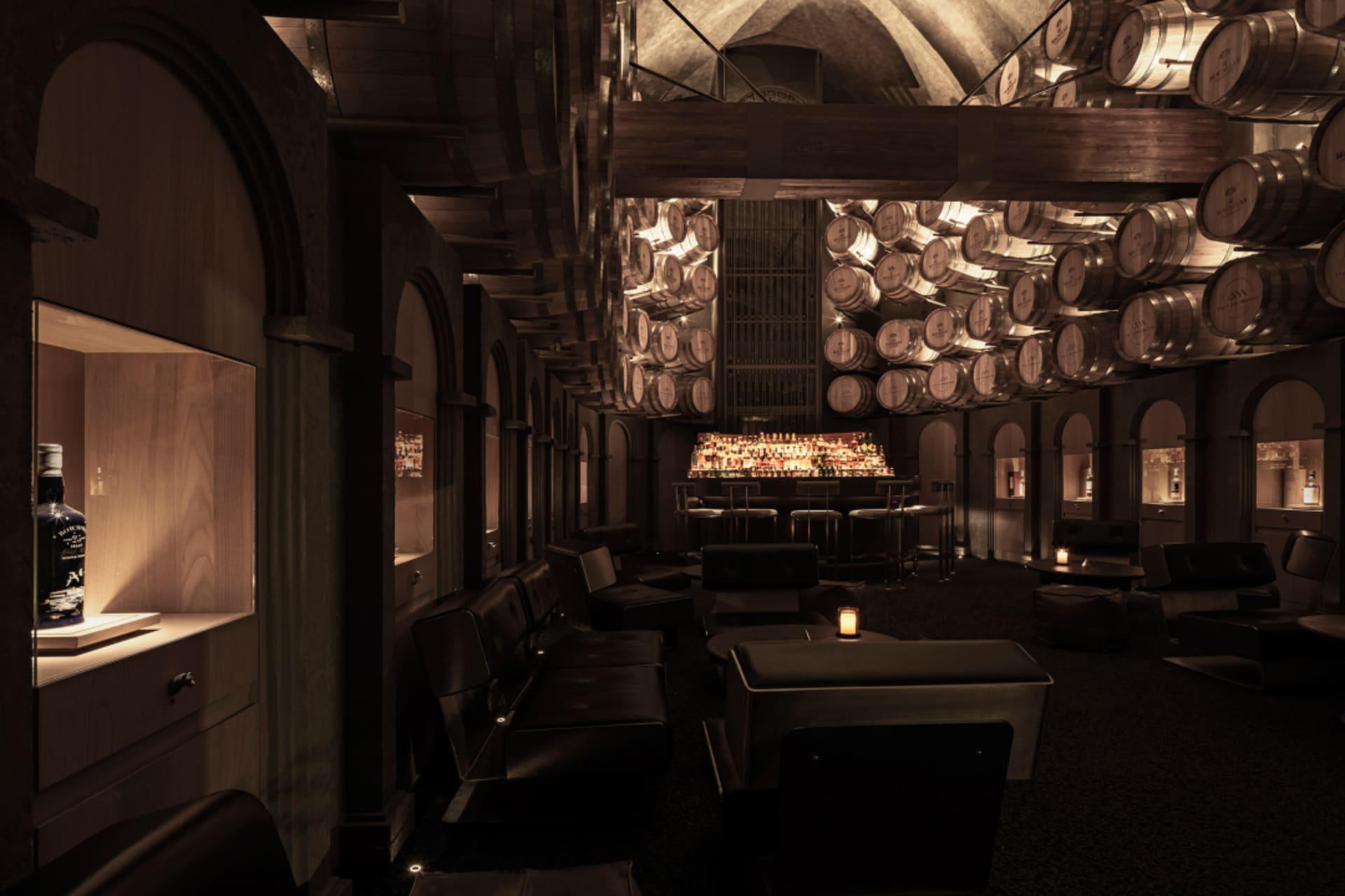 Cozy bar area with wooden walls and ceiling, featuring a dining table, chairs, and scattered bottles, creating a warm and inviting atmosphere