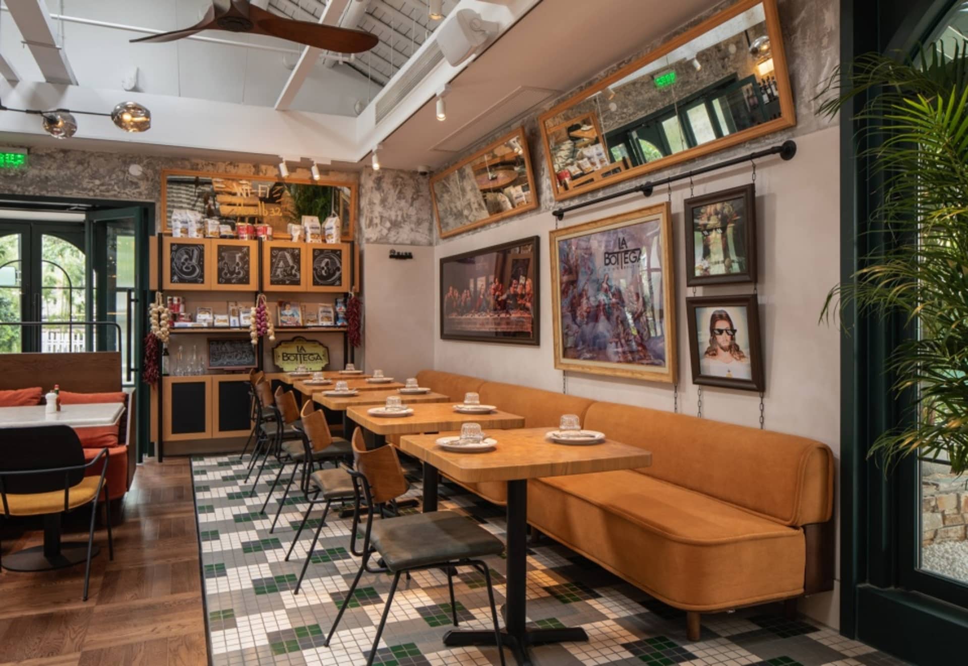 A well-lit restaurant dining area with multiple tables and chairs, white tablecloths, and a comfortable atmosphere
