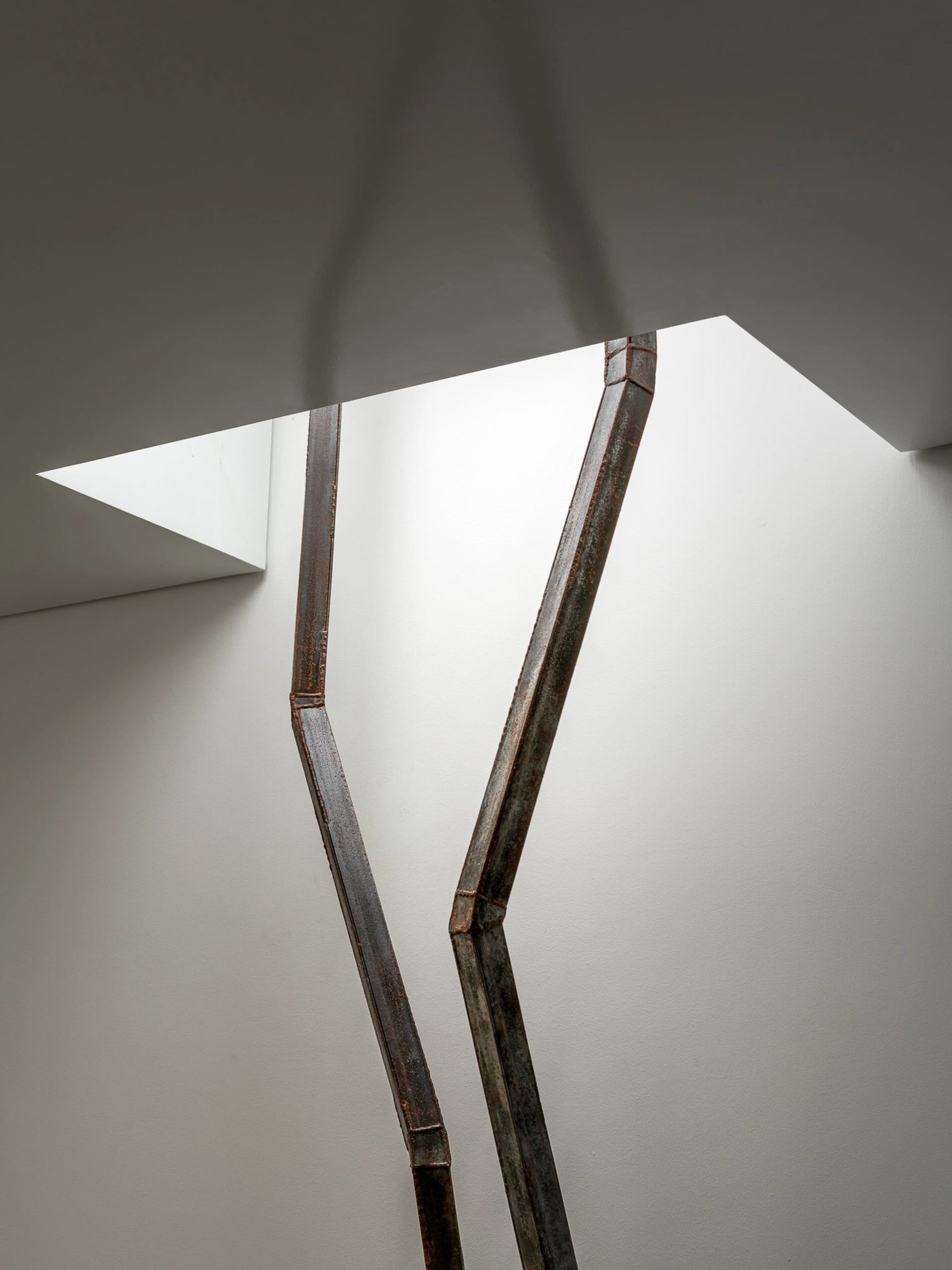 Modern interior space with metal sculptures integrated into the walls, creating a sophisticated atmosphere with well-lit surroundings