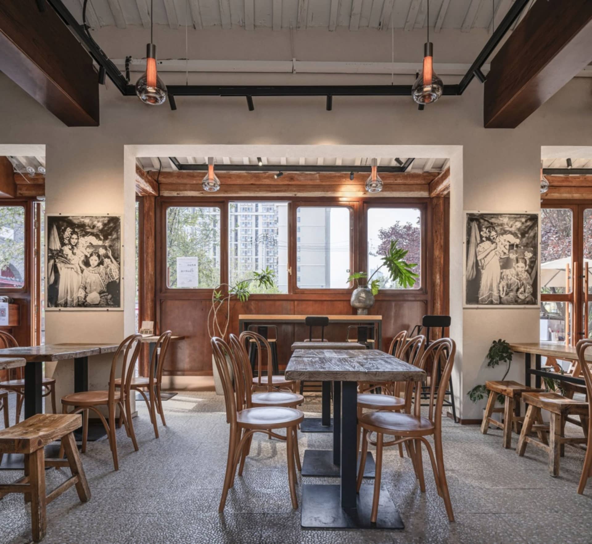Warm and inviting restaurant interior with wooden tables and chairs, scattered dining tables, and cozy atmosphere