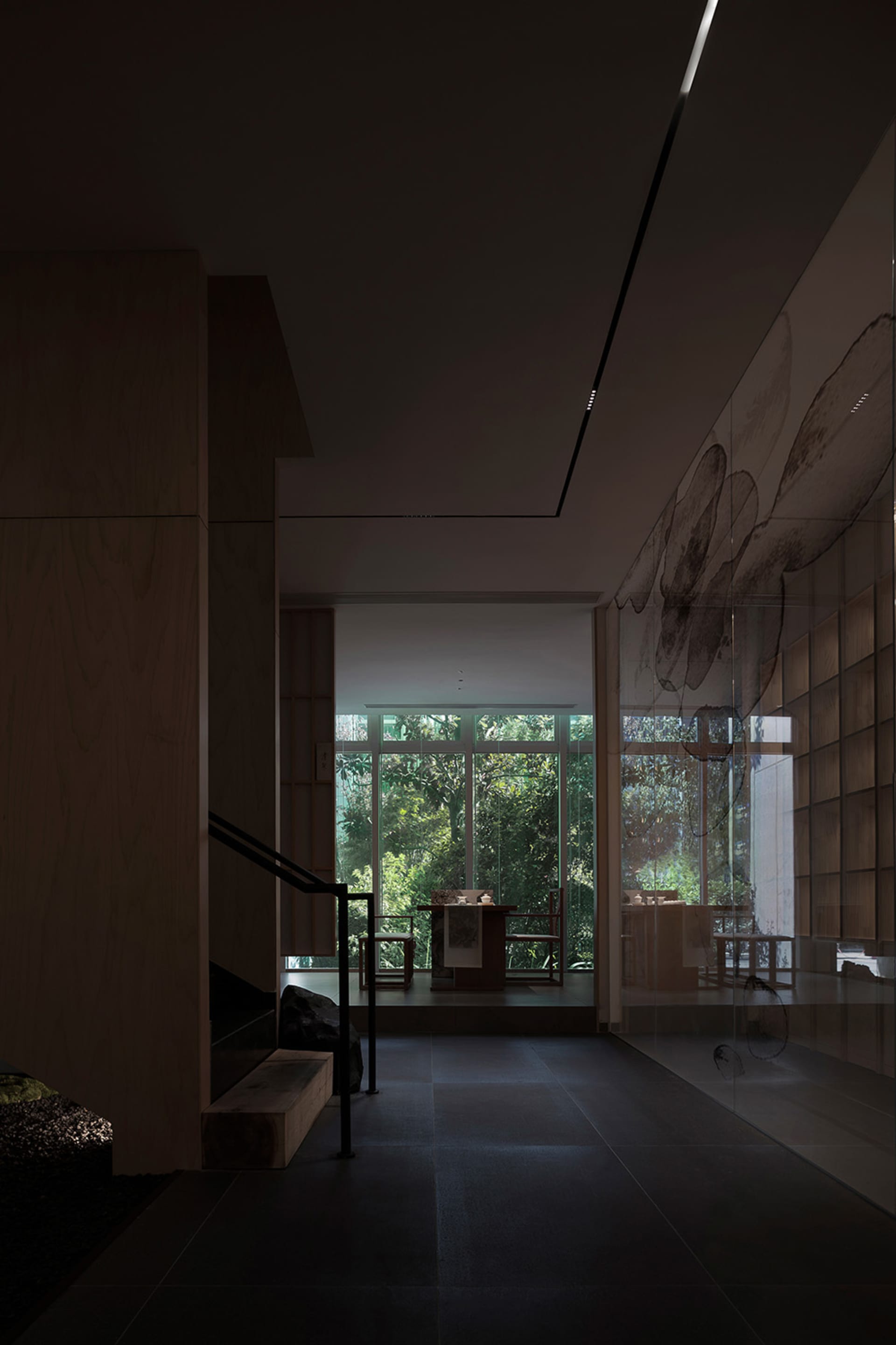 Cozy living space with wood flooring and walls, featuring a couch, chairs, dining table, and bench