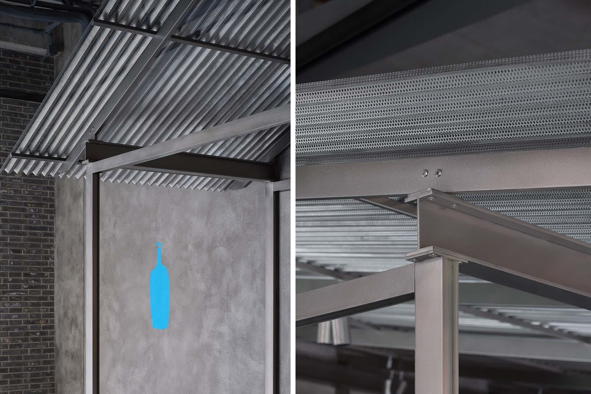 Industrial building ceiling with metal beams, metal pipes, and steel beams, showcasing the building's structural elements
