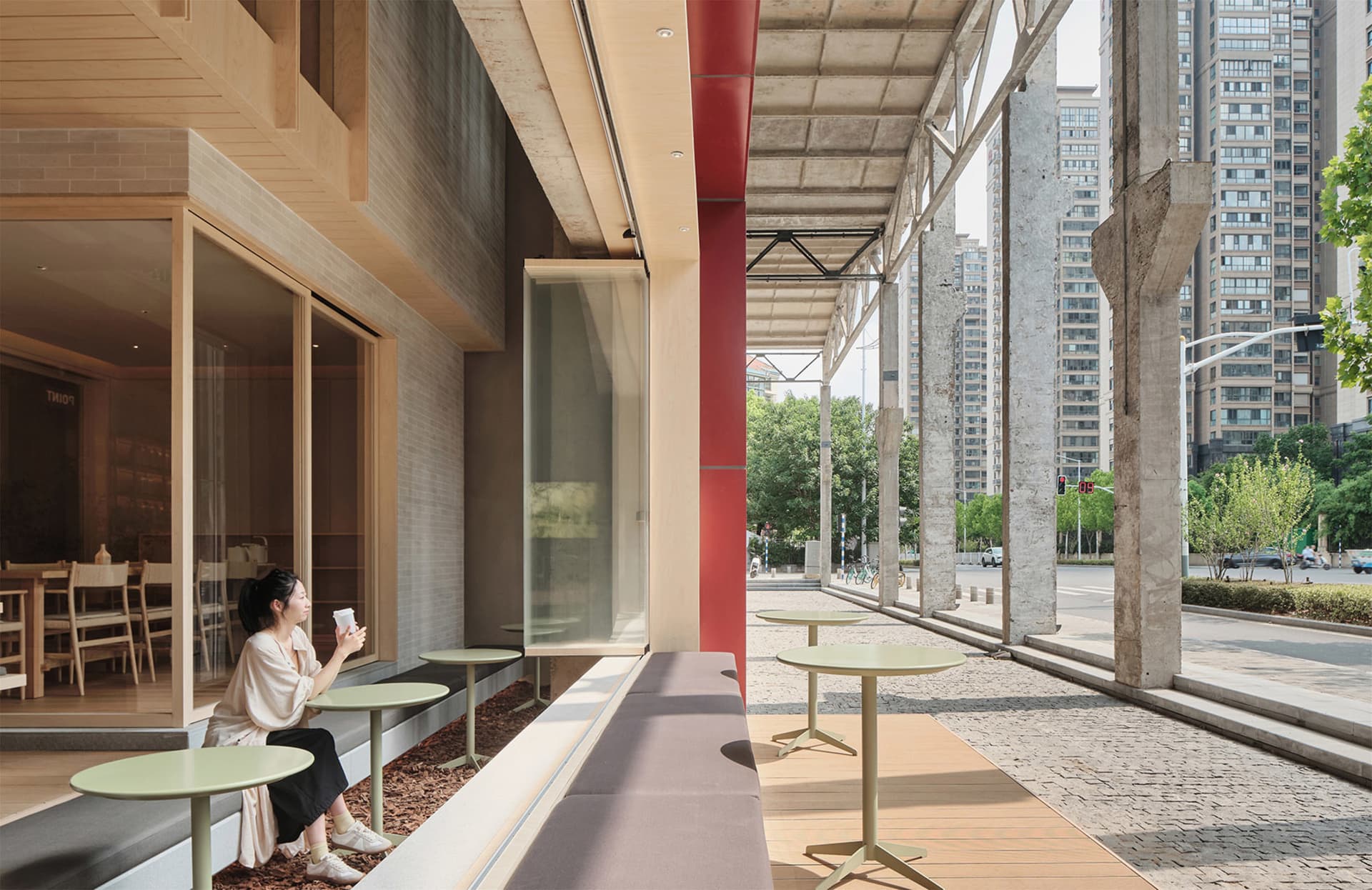 A dining area with tables and chairs arranged along a window, creating an inviting space for socializing and enjoying meals together