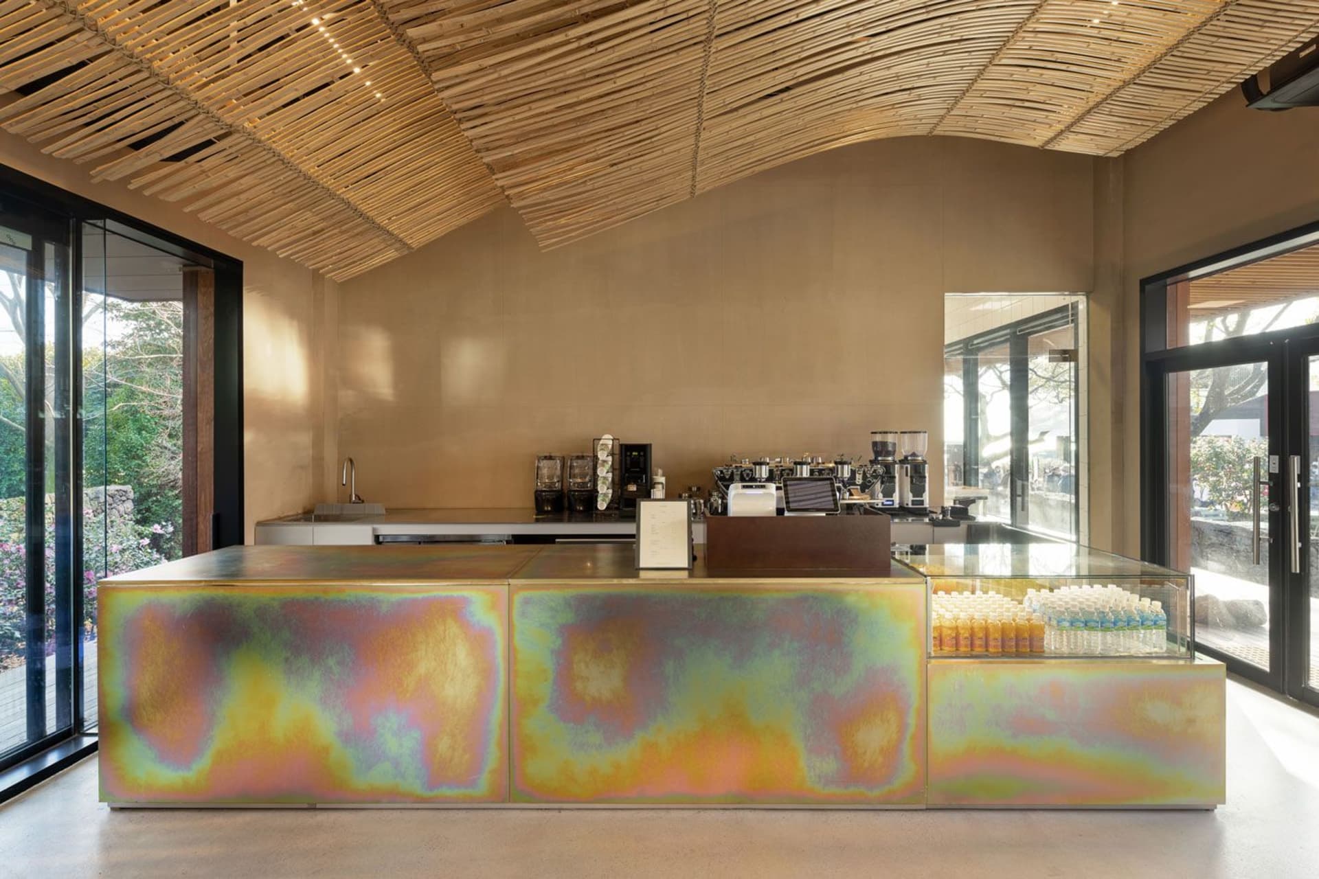A casual coffee shop interior with a counter, sinks, and various items on display, creating a welcoming atmosphere for customers
