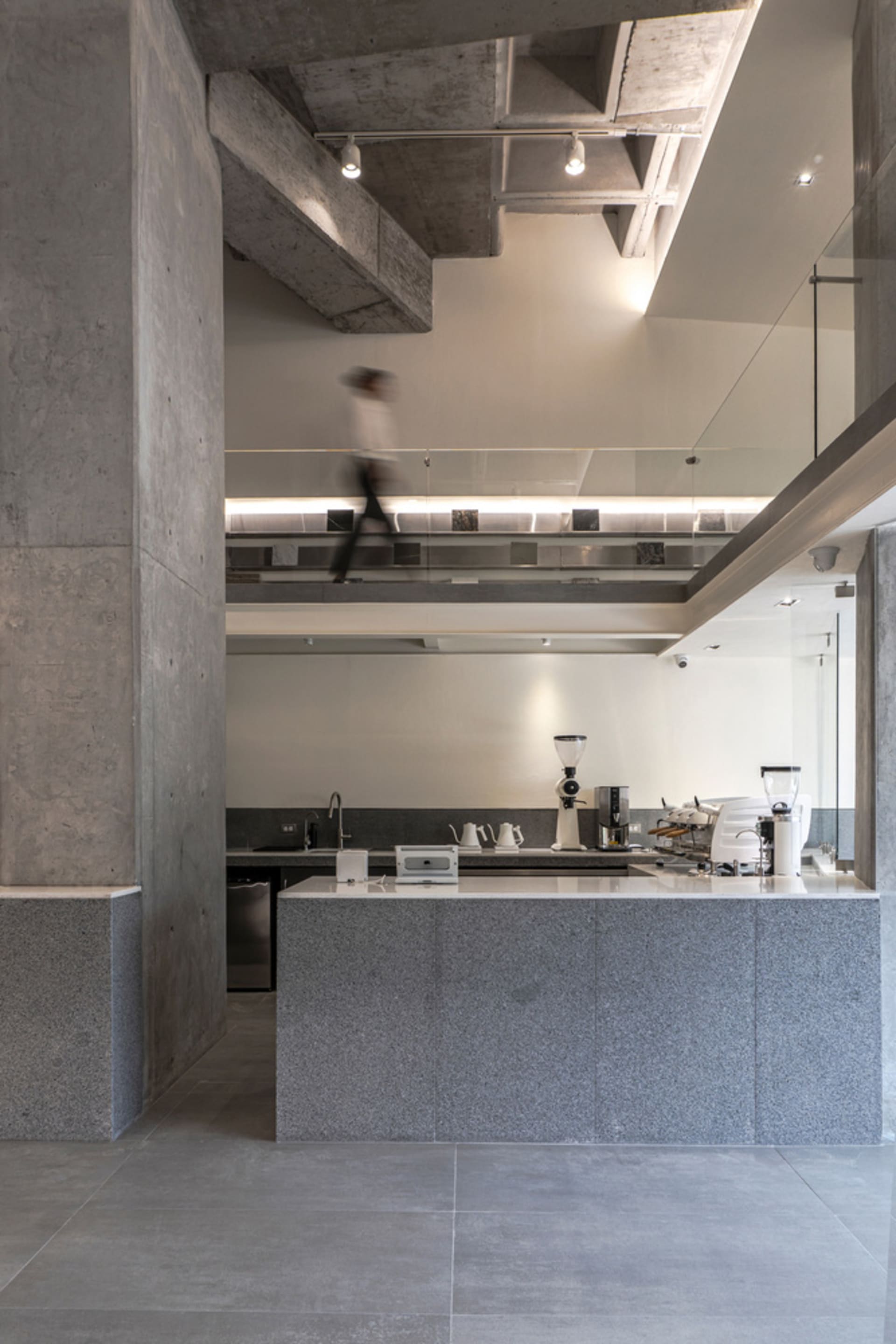 An open kitchen with a large island, sink, refrigerator, and various kitchenware, creating a lived-in atmosphere for socializing and cooking