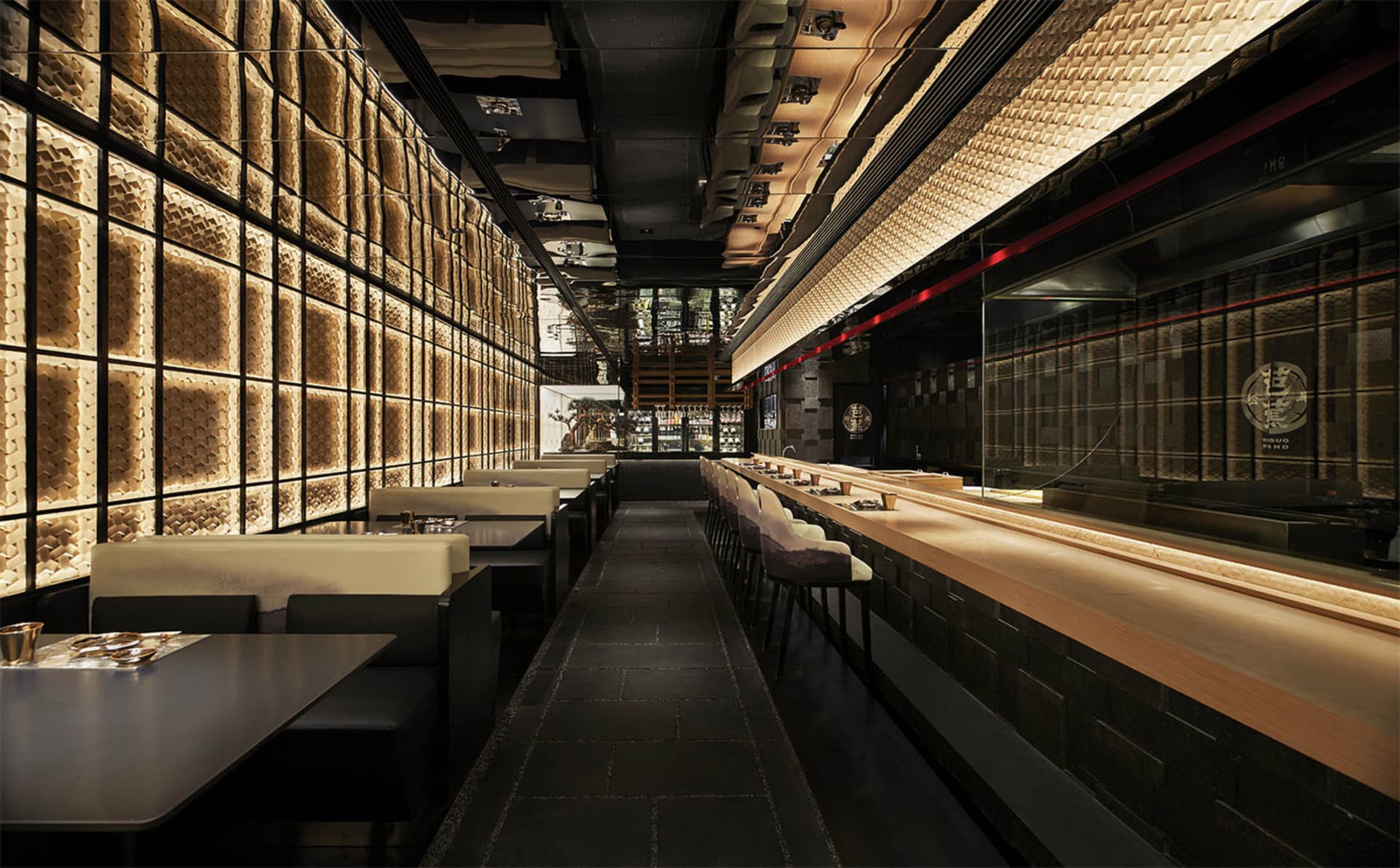 Modern restaurant interior with a long wooden bar, chairs, and an inviting atmosphere