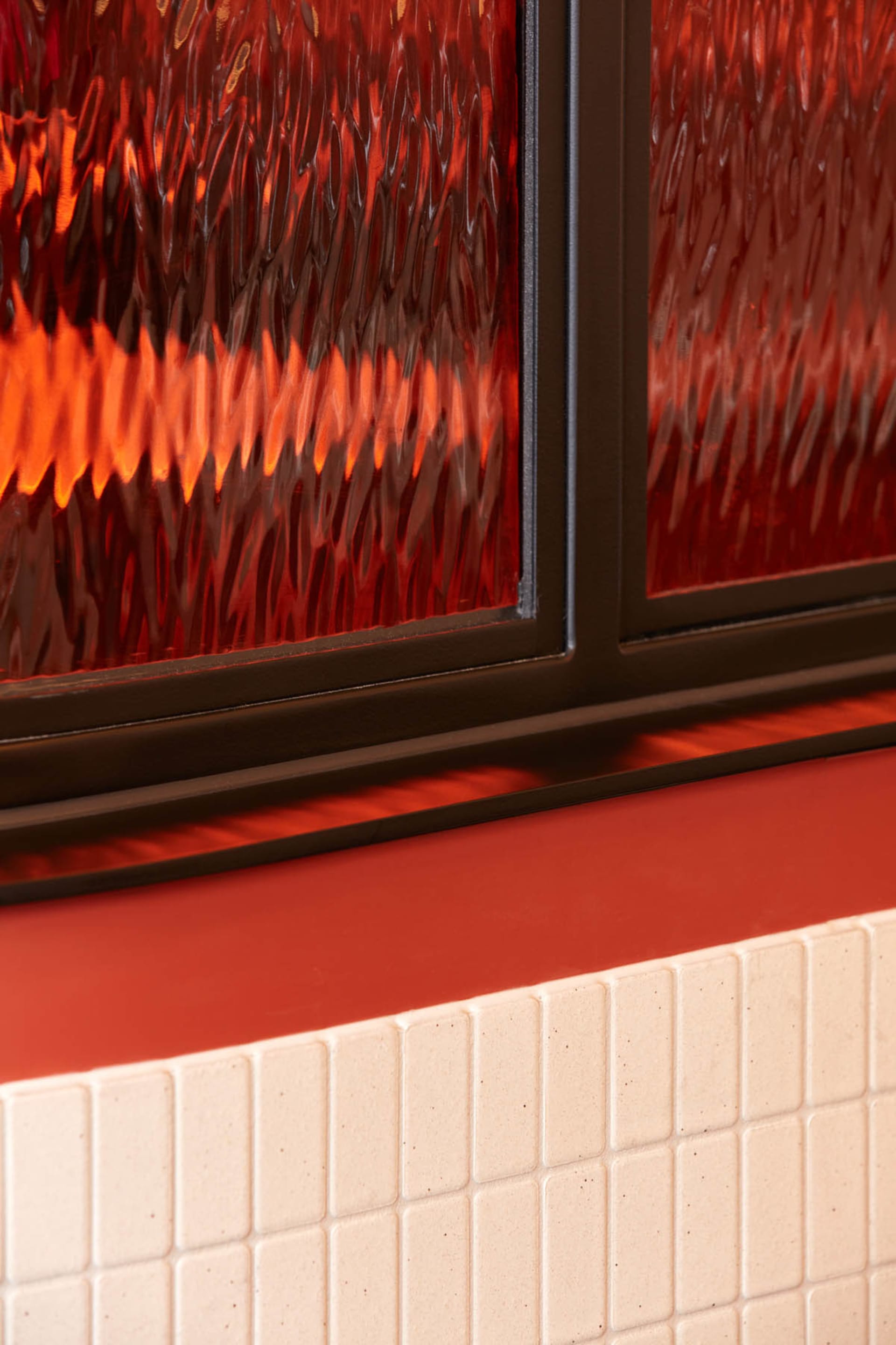 Interior view of a residential space with red trim, two people, and a warm atmosphere