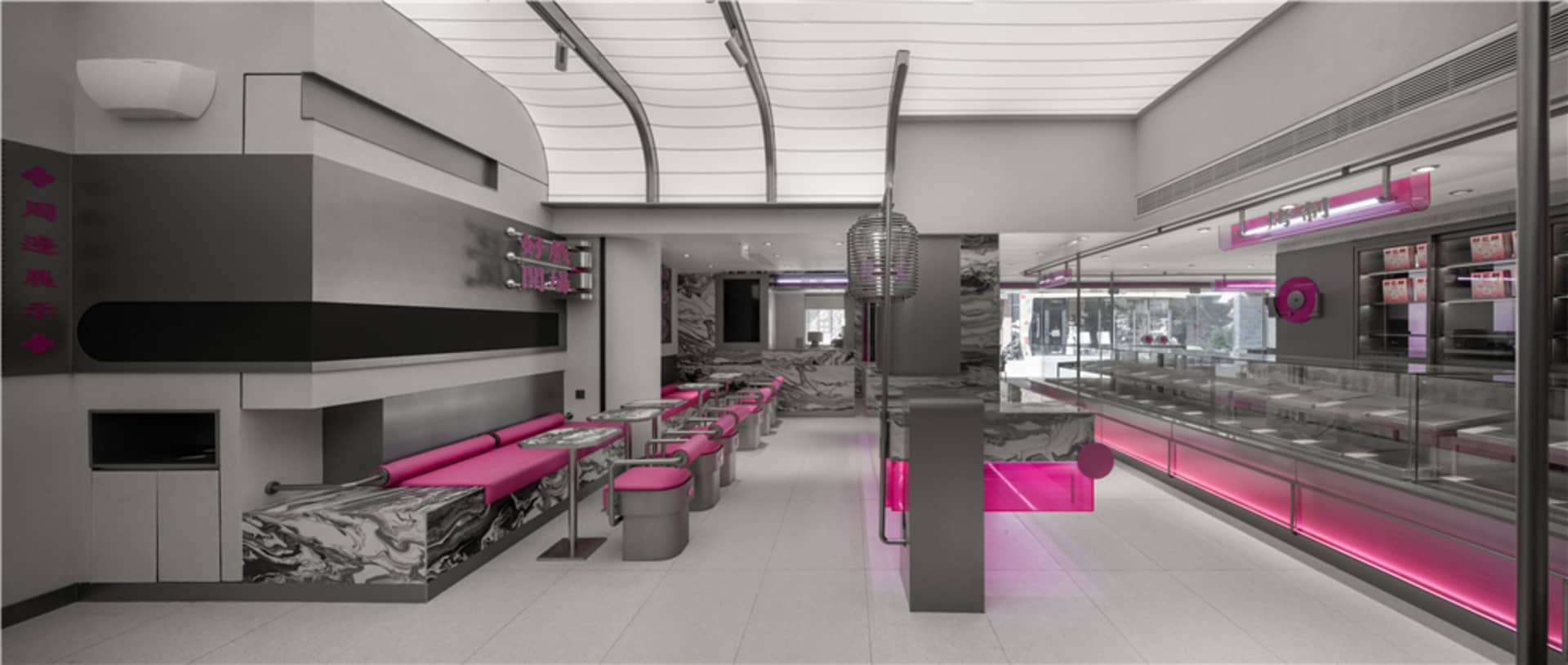A modern restaurant interior with pink accents, artwork on the walls, and ample seating for guests