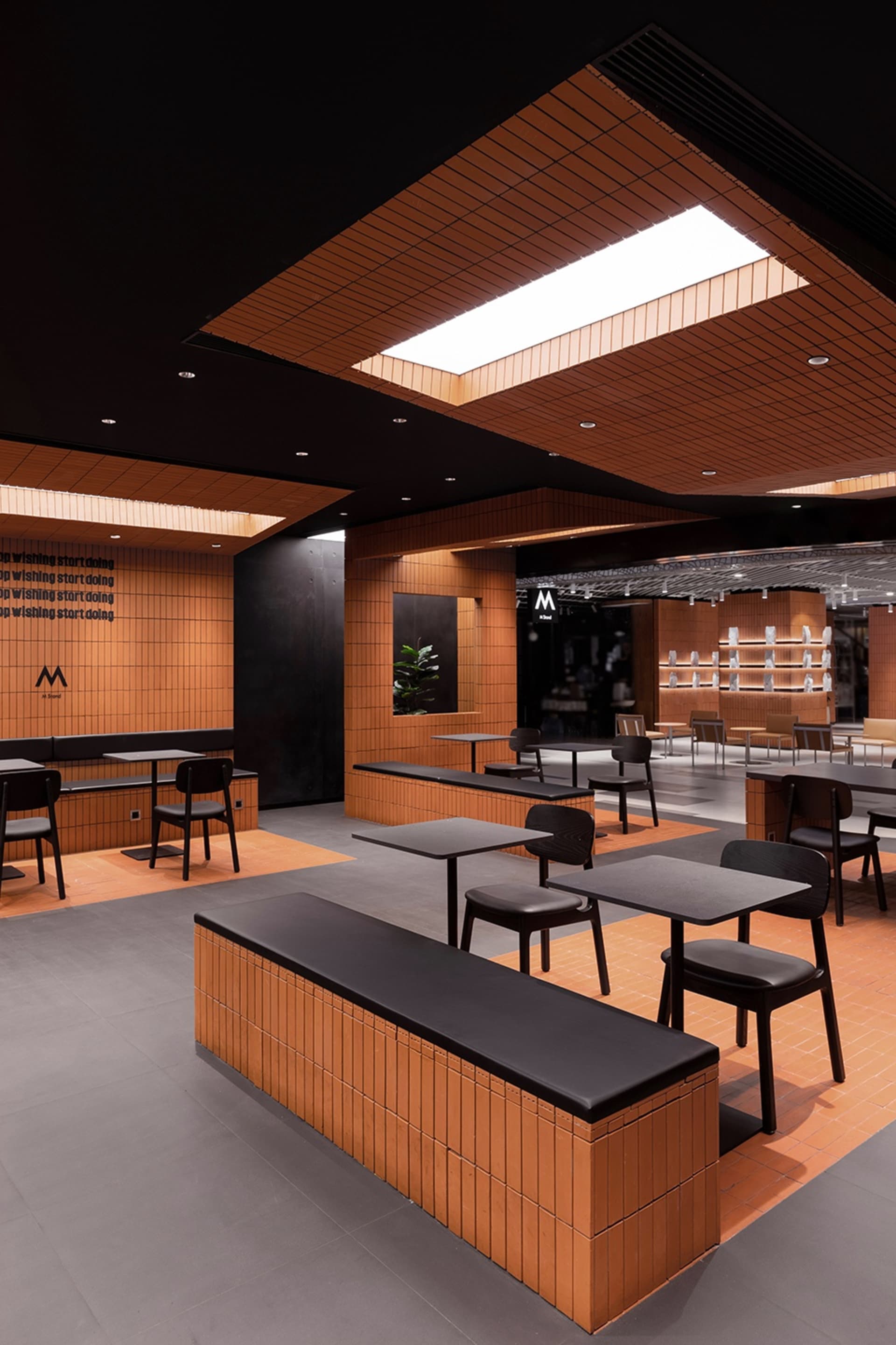 A well-lit restaurant interior with wooden floors and tables, featuring comfortable seating and a welcoming atmosphere