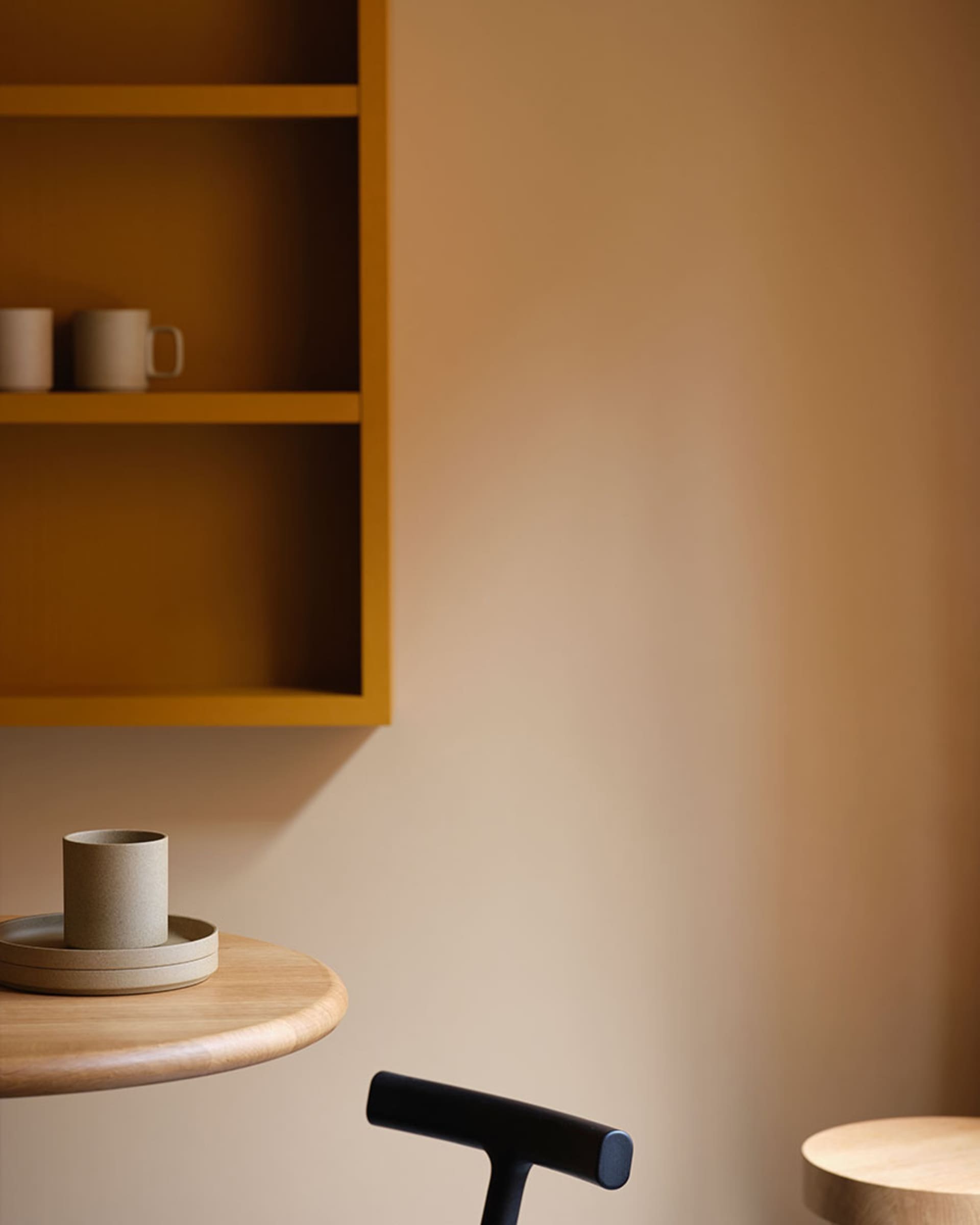 A cozy living area with a wooden table featuring two cups and two bowls, surrounded by a warm and inviting atmosphere
