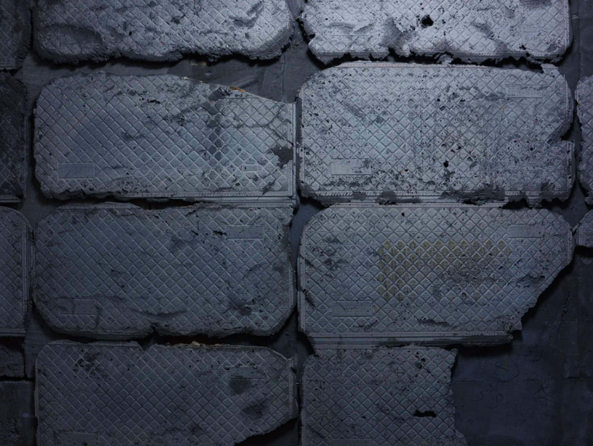 A dimly lit architectural floor plan of an old building with concrete walls and various rooms