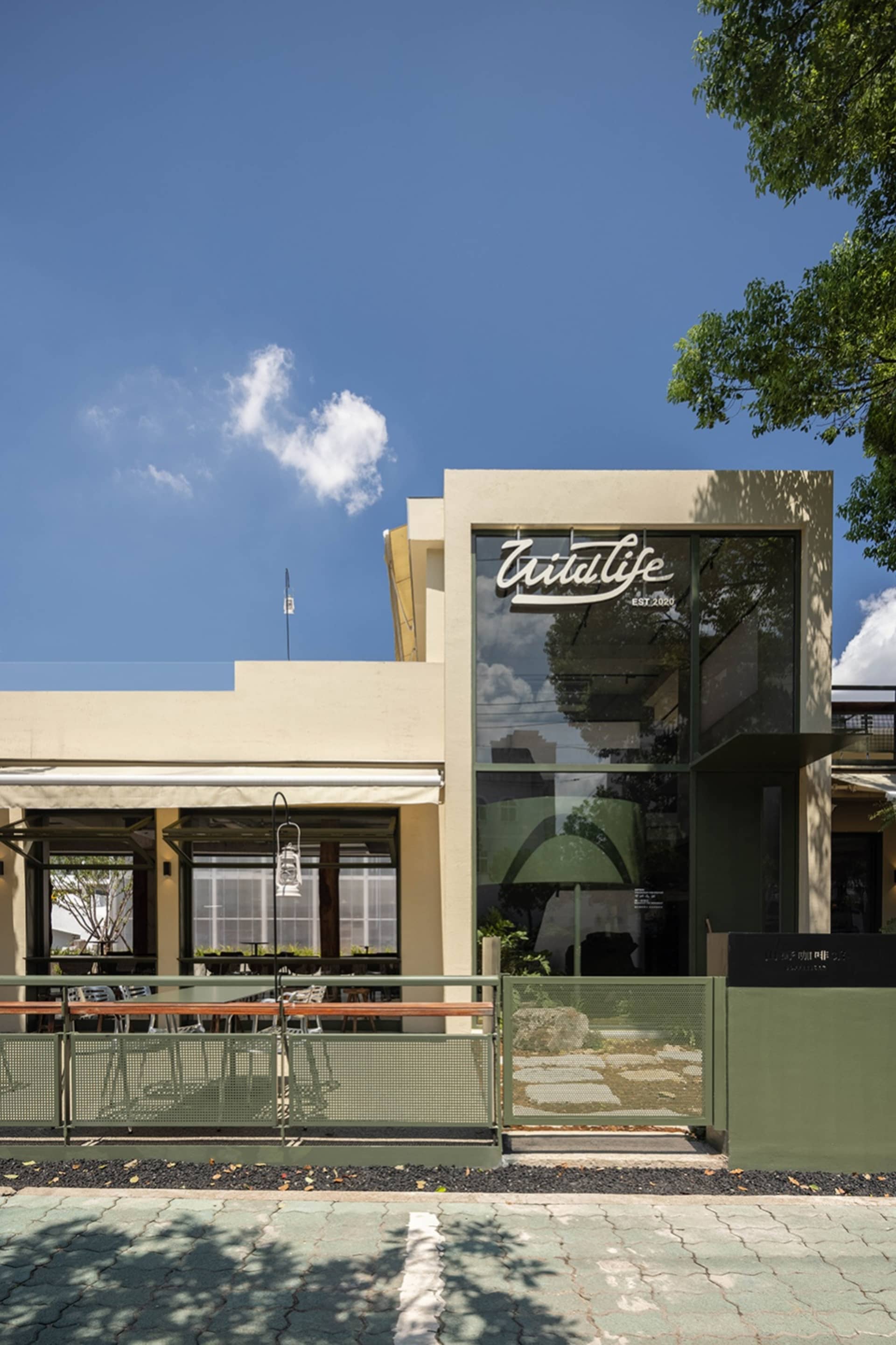 A dining table surrounded by wicker chairs in an outdoor restaurant patio area, with a relaxed and inviting atmosphere