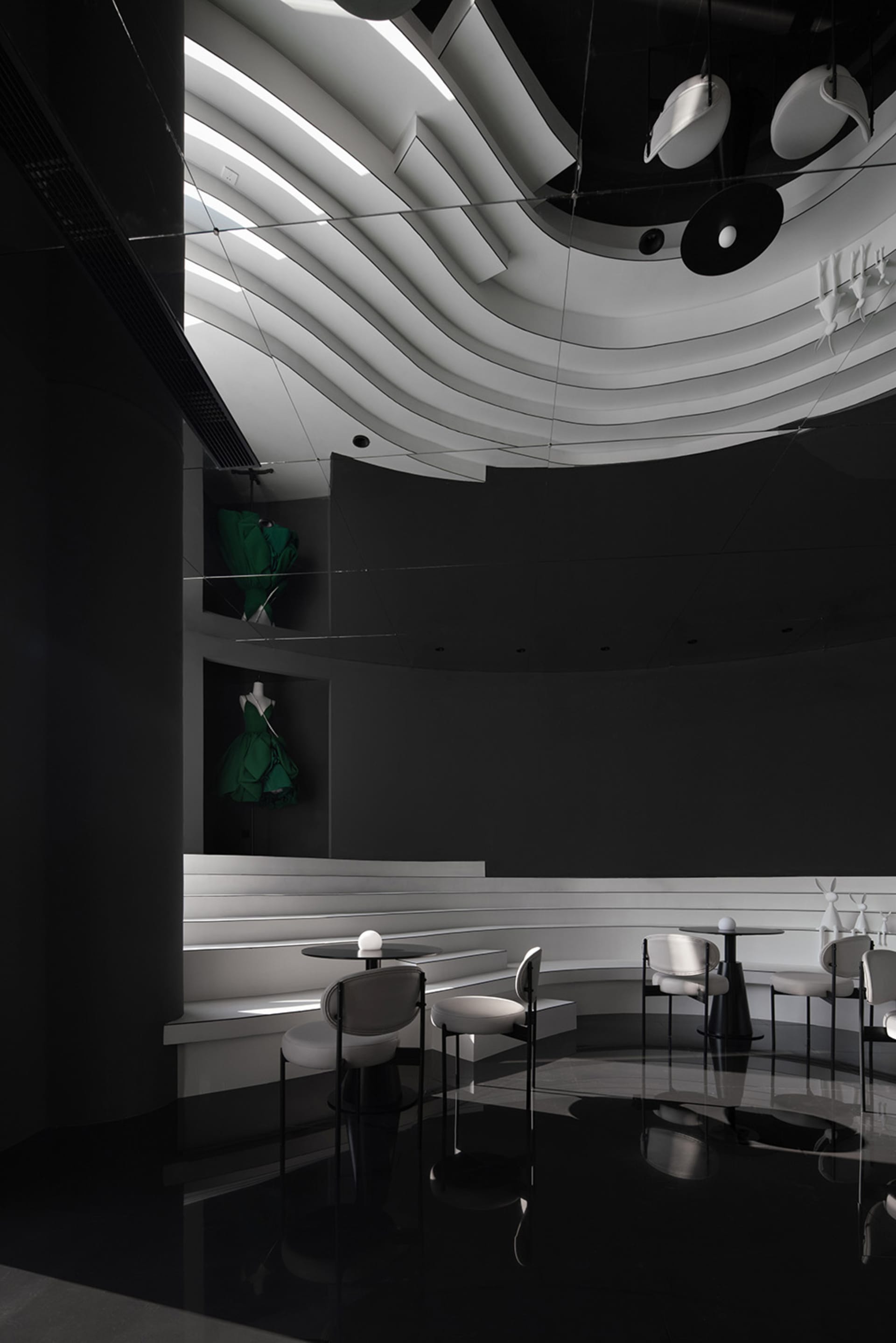 Elegant dining space with multiple tables and chairs, white table tops, and a clean modern atmosphere
