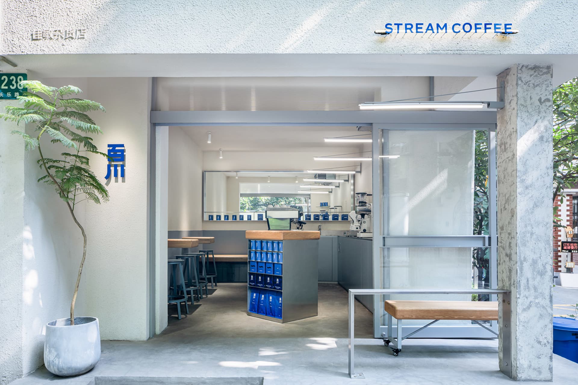 Open coffee shop with modern design, natural light, and comfortable seating areas