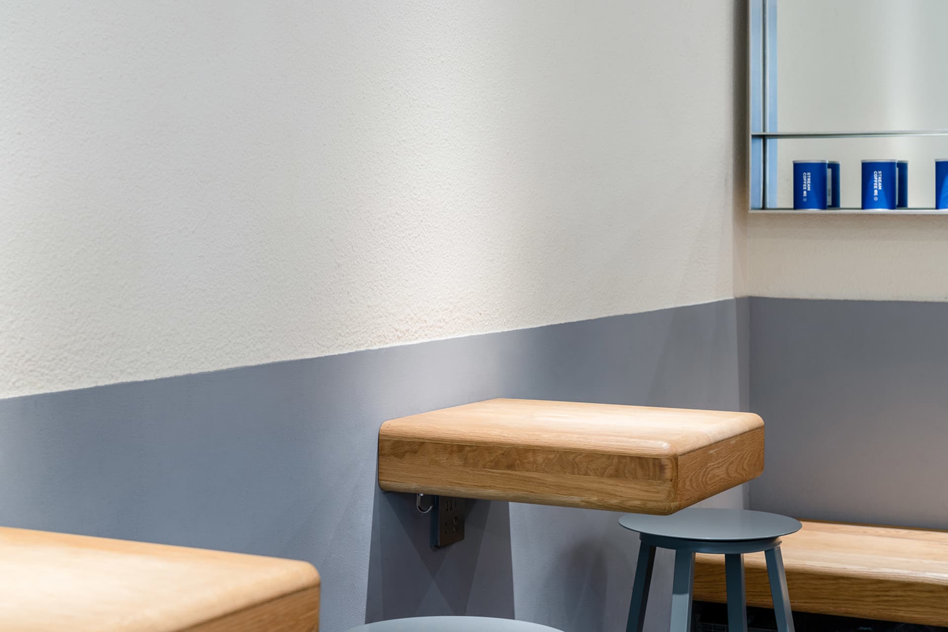 Warm and inviting restaurant interior with wooden tables and chairs, featuring two dining areas with seating options