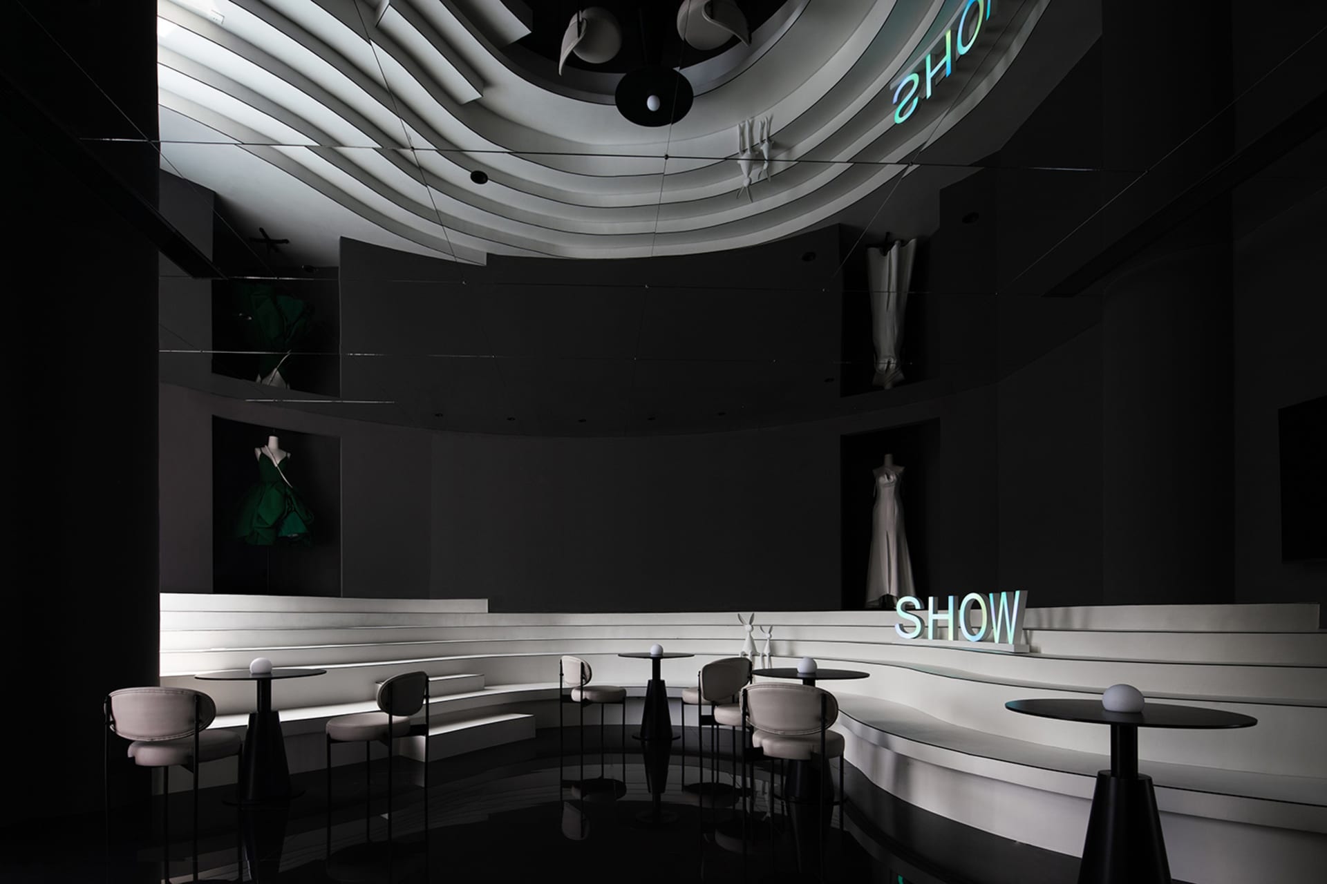 Elegant restaurant seating area with a circular layout, featuring multiple chairs and dining tables with various items, such as cups, bottles, and vases