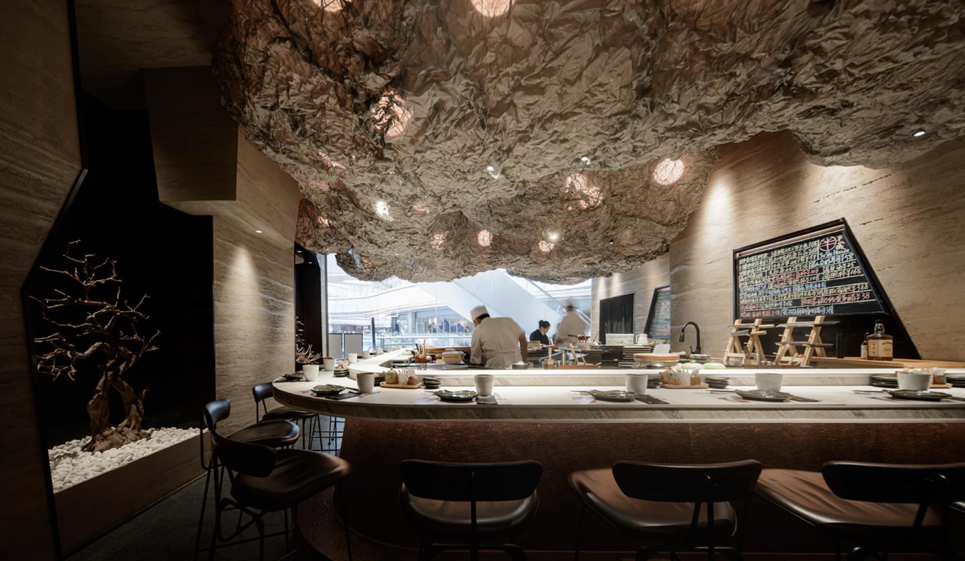 Inviting restaurant interior with a bar, stools, chairs, and dining tables, featuring a mix of hot and cold beverages and meals