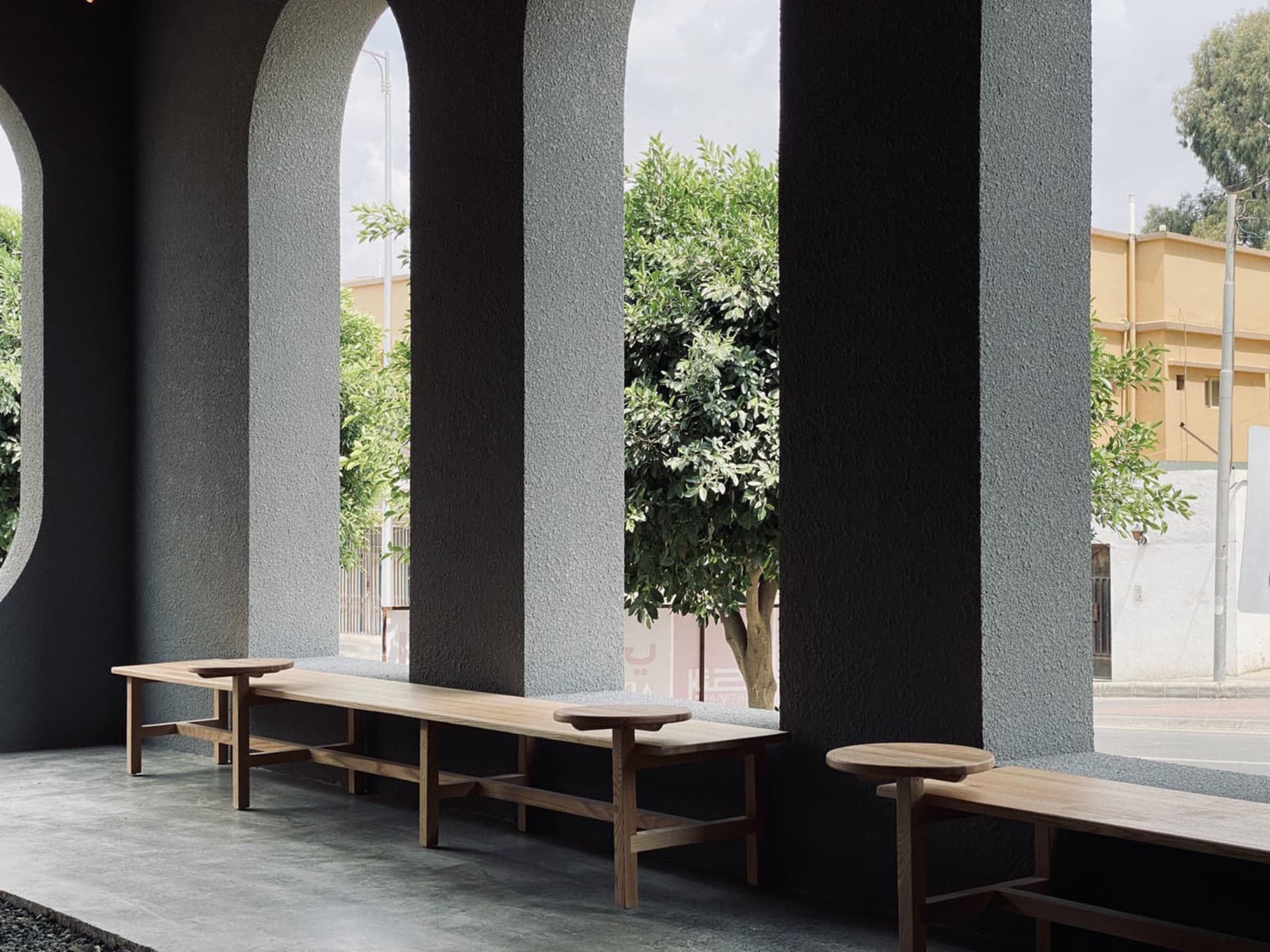 A calm and inviting lobby with benches arranged for socializing, featuring a neutral color palette and ample space for visitors to relax