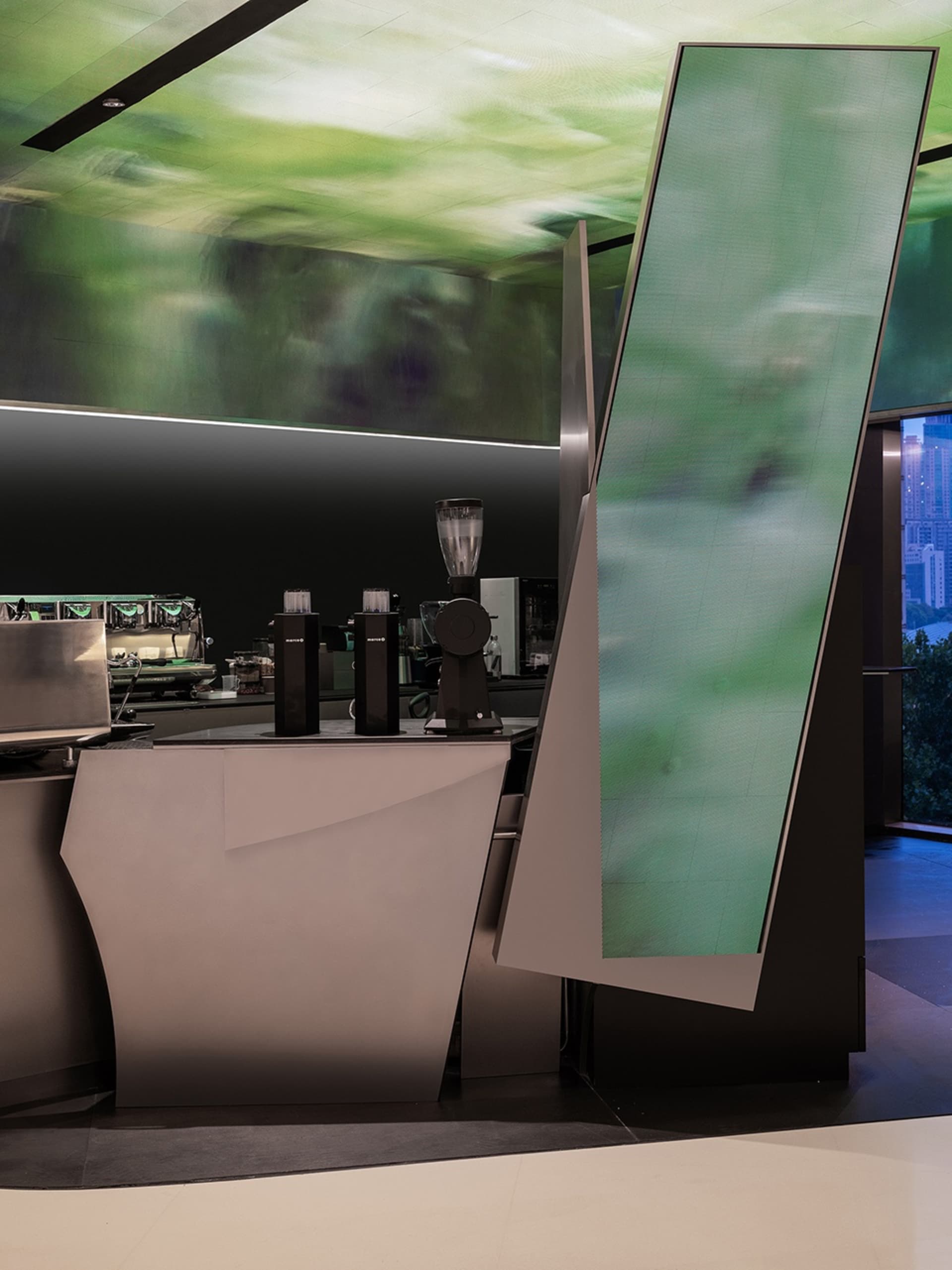 A coffee shop interior with a counter featuring cups, a bowl, a vase, and bottles, creating an inviting atmosphere