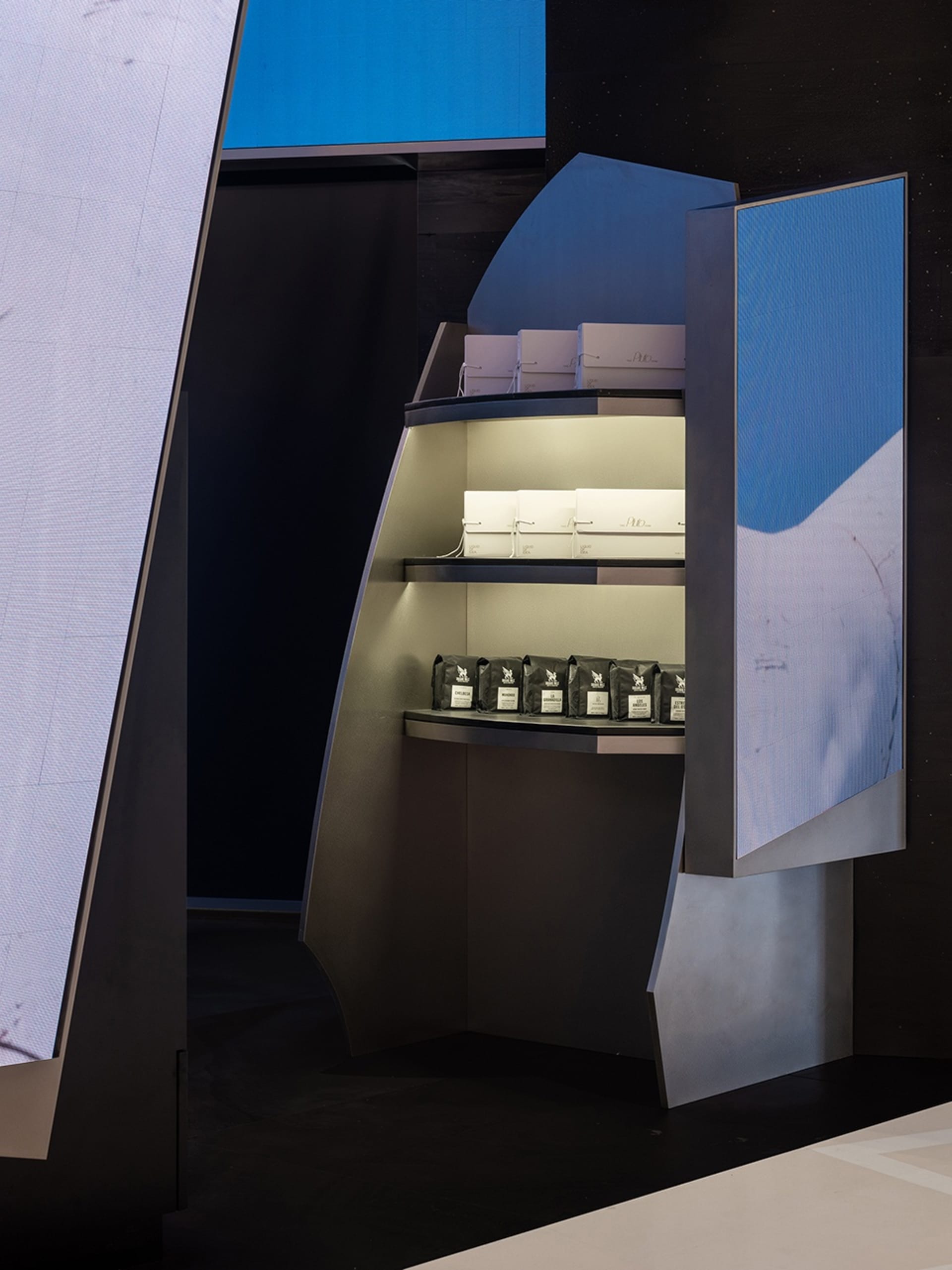 A clean and organized retail display featuring a coffee counter with cups, bottles, and bowls, designed to showcase products and attract customers