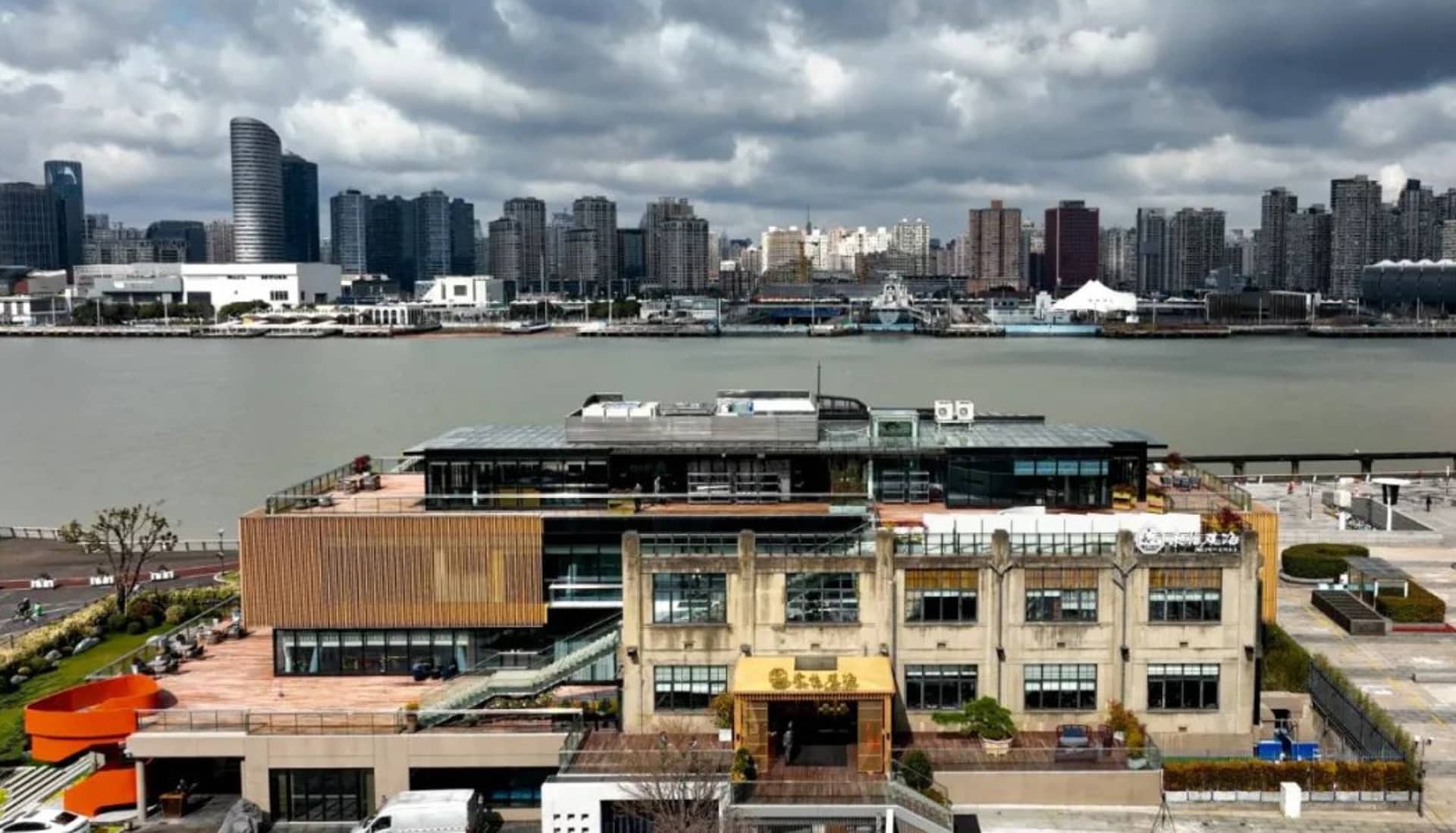 A bustling city scene with a mix of architectural styles, trees, and parked cars, showcasing a lively urban environment