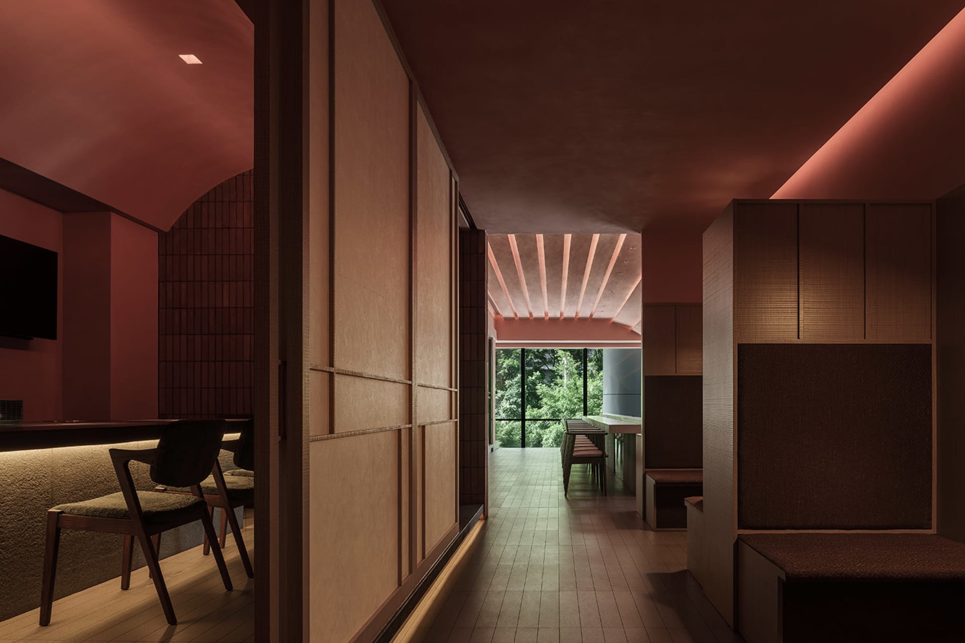 A warm and inviting dining space with wooden walls and floors, featuring a dining table and chairs