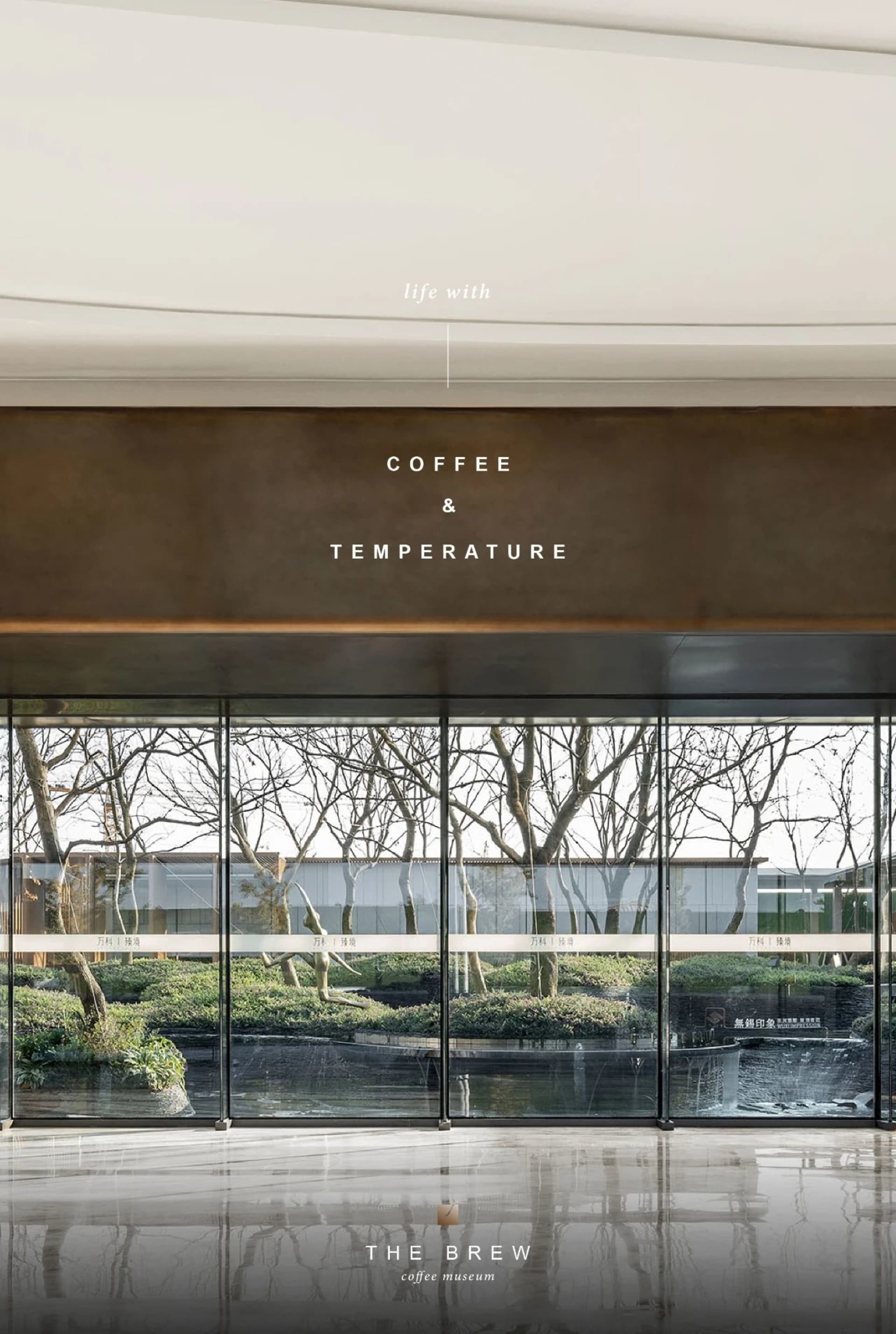 Modern office space with a large glass wall, a coffee and temperature sign, and natural light from the window