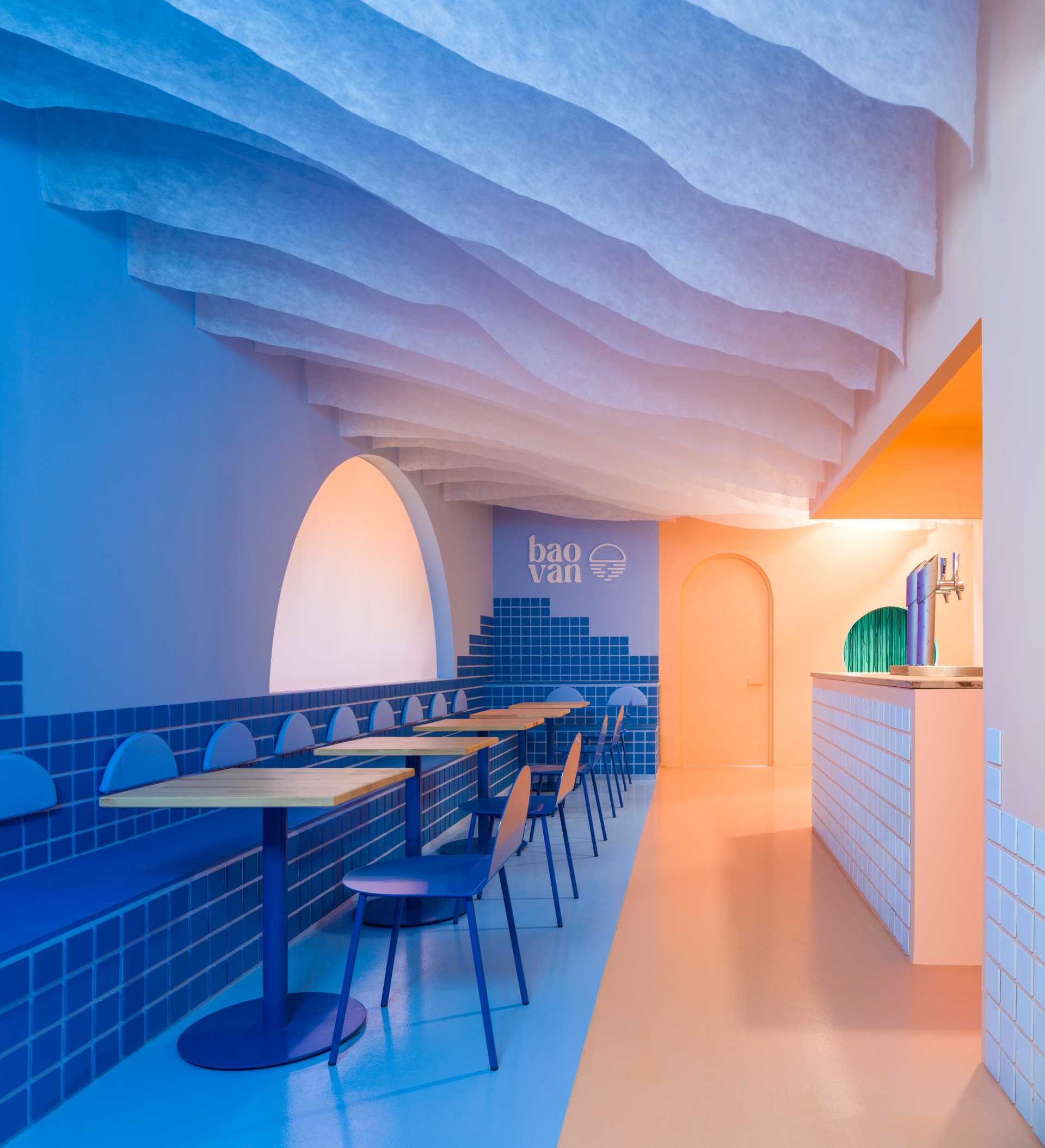 A restaurant dining area with multiple tables and chairs, creating a welcoming atmosphere for meals and socializing