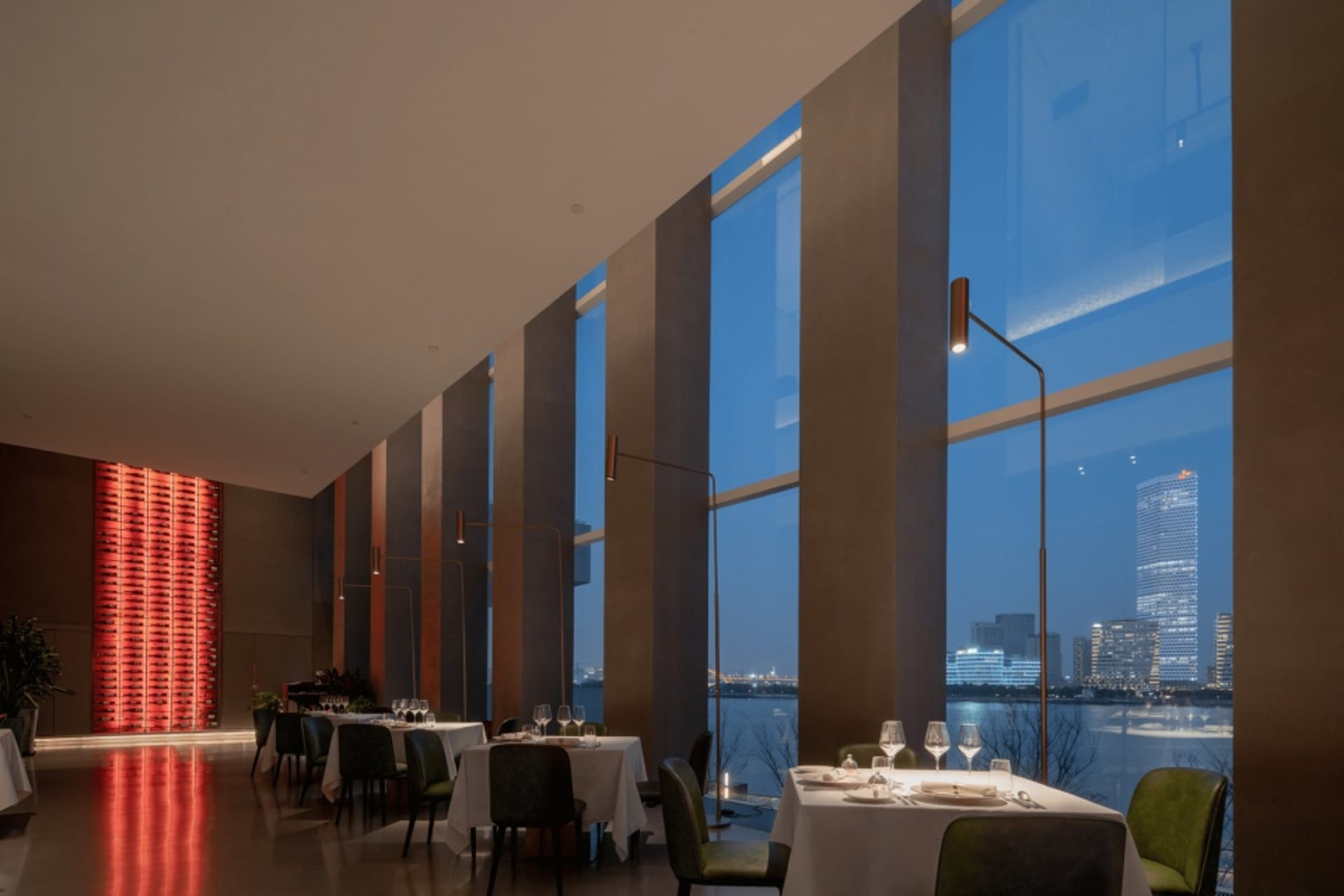 Elegant restaurant interior with tables, chairs, and candlelight, set against a sophisticated backdrop