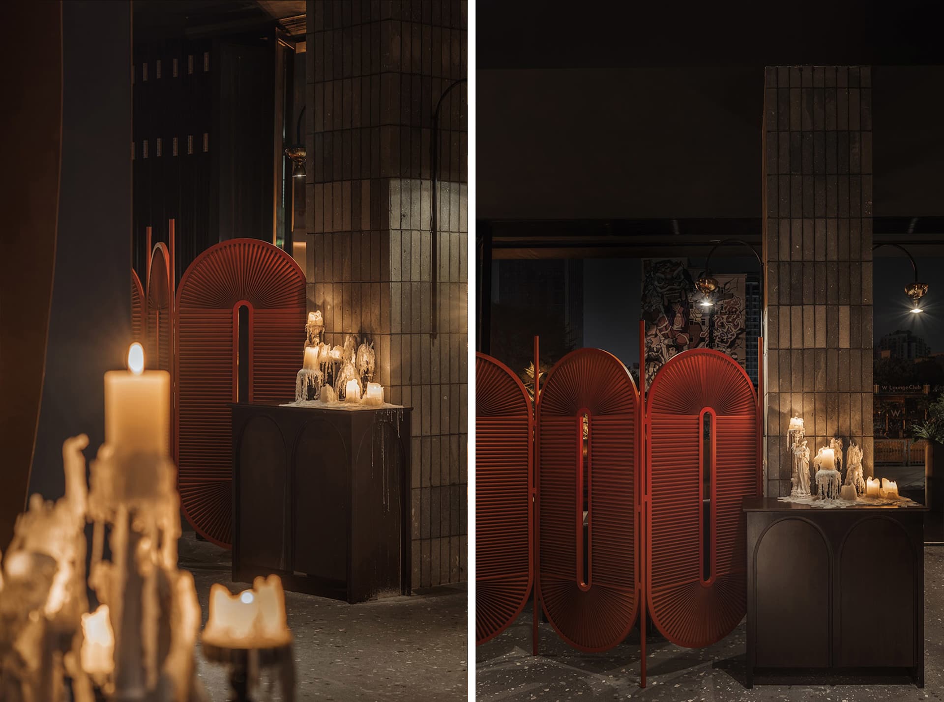 Dimly lit modern space with red accents, candles, and a mix of living and dining areas