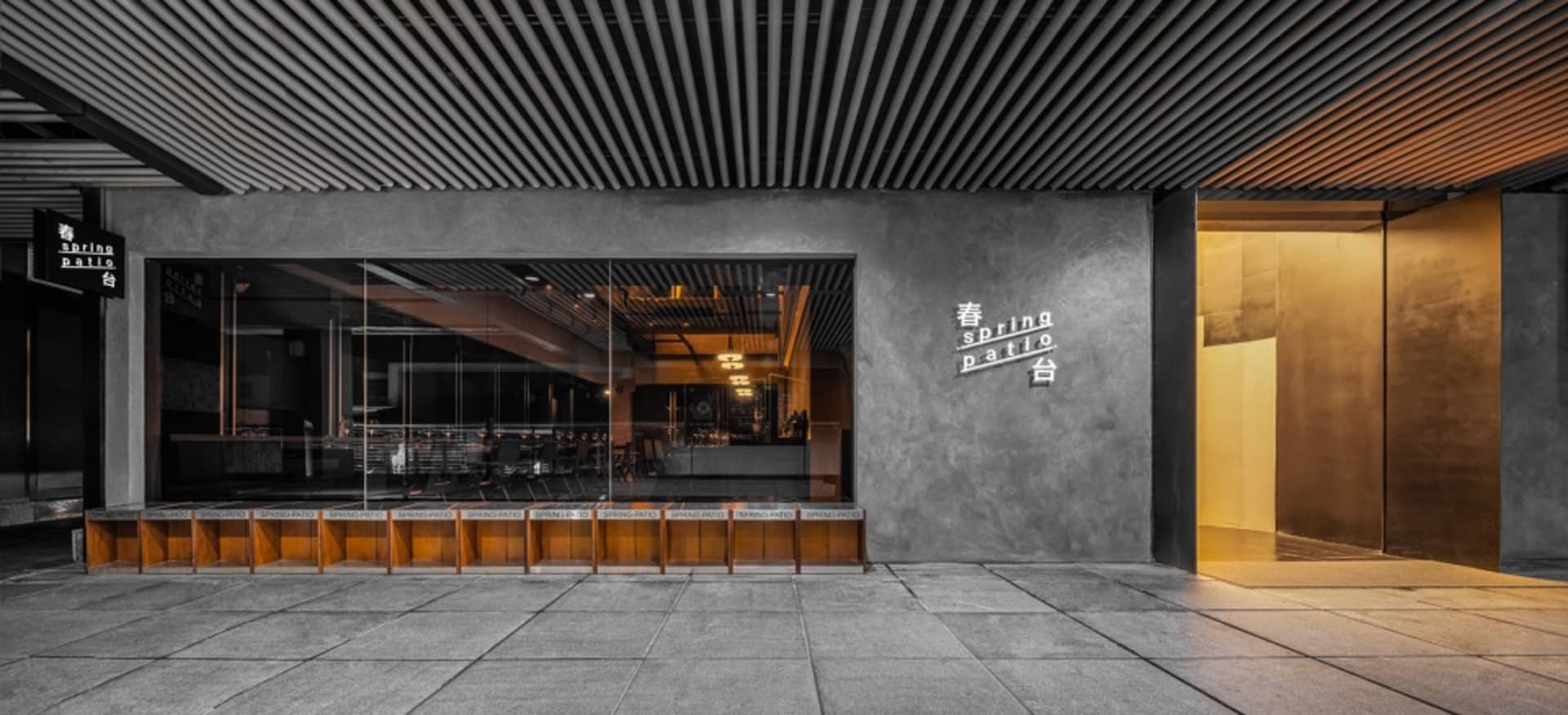 Empty restaurant with wood flooring, a glass wall, and natural light from a large window