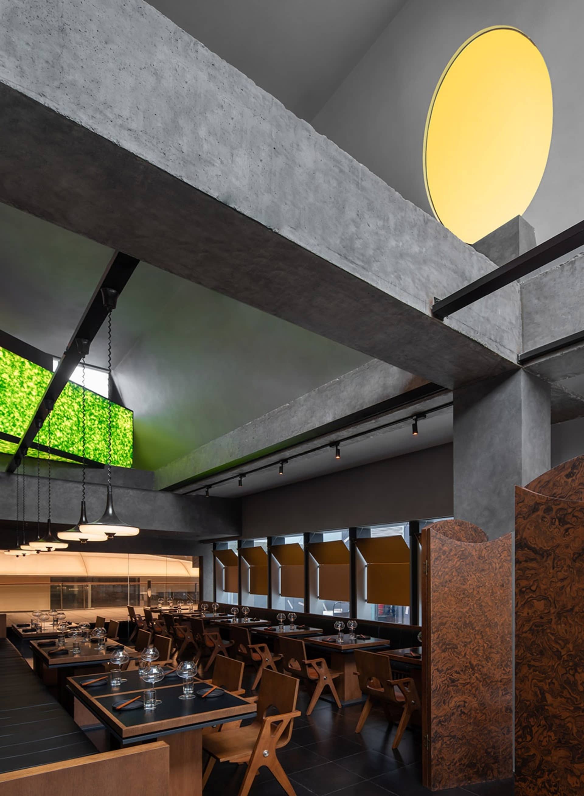 A warm and inviting dining space with a large wooden table and chairs, wine glasses, and a comfortable atmosphere