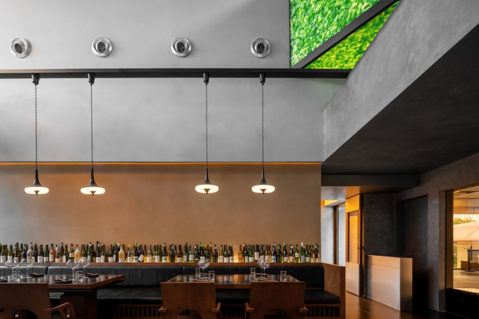 Cozy restaurant interior with a dining table, wine bottles, and inviting atmosphere